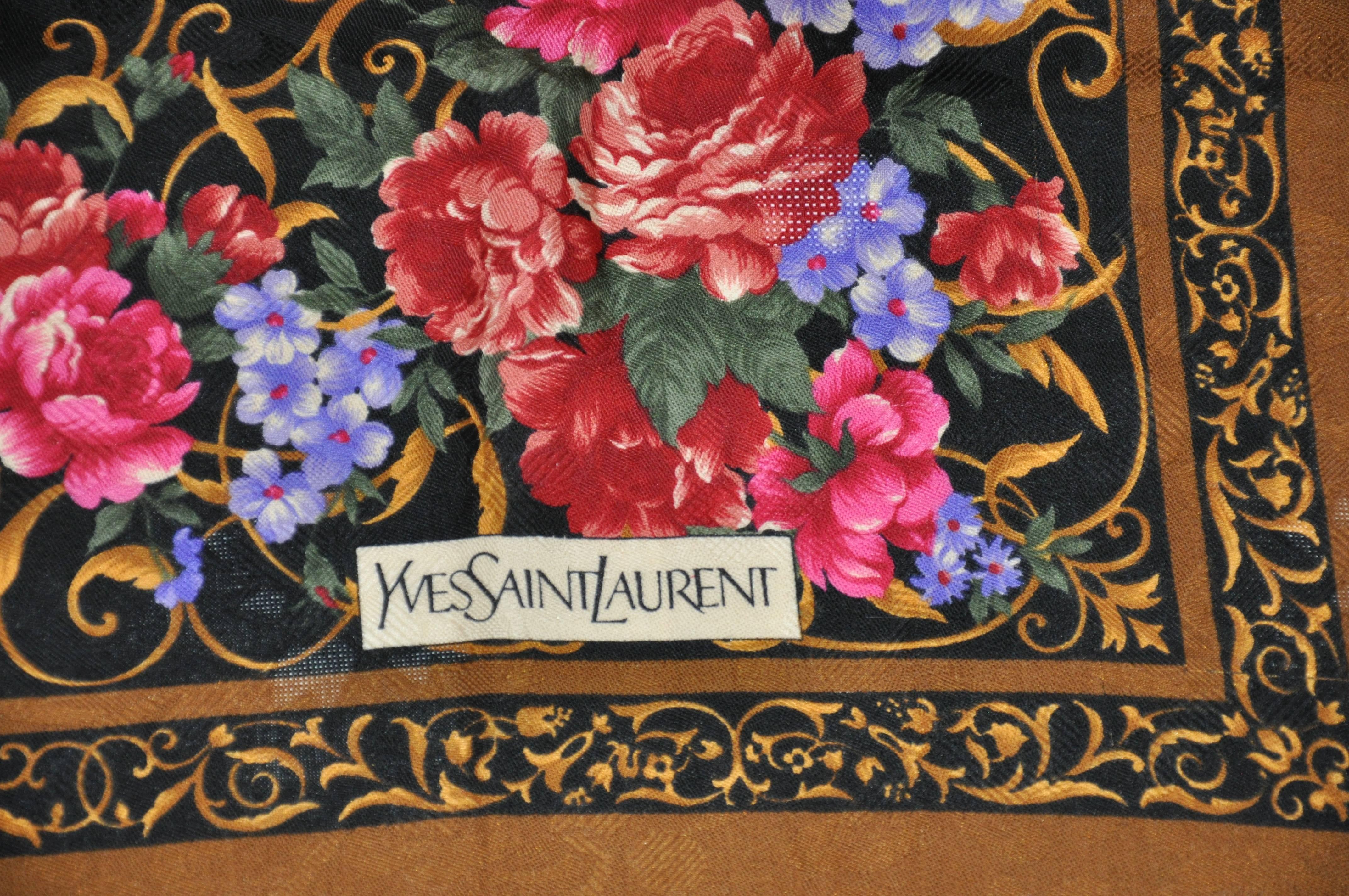        Yves Saint Laurent huge coco-brown border surrounding a multi-color floral center is made of wool challis from France. This huge scarf measures 43 inches by 44 inches. Made in France. There are a few tiny pin holes, but hardly noticeable.