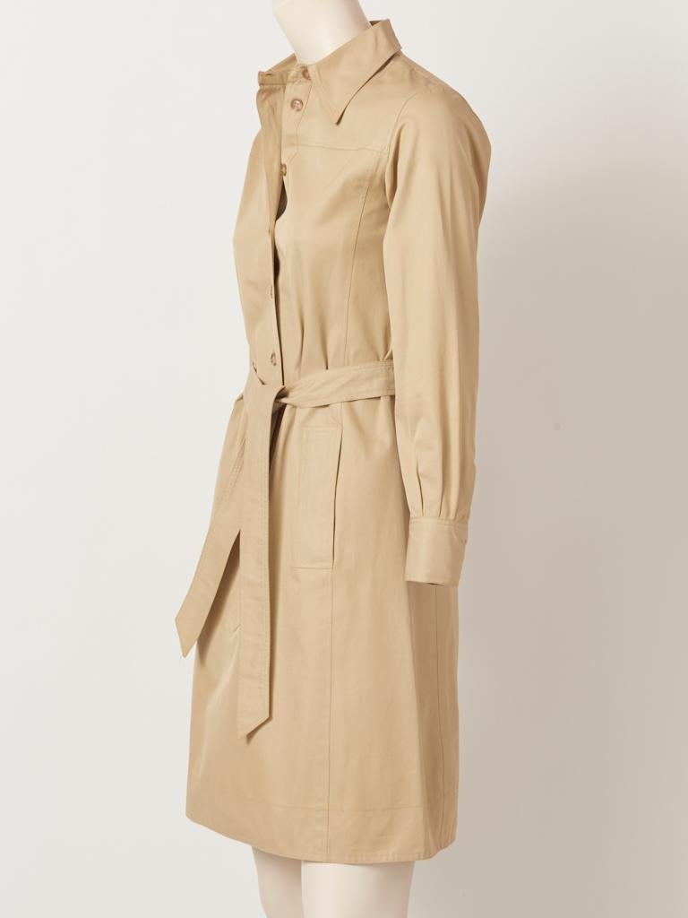 Yves Saint Laurent, RIve Gauche, iconic, late 70's, Khaki, long sleeved, belted shirt dress, having a pointed collar, button down front and slash pockets at the hip. Slightly A line silhouette. 