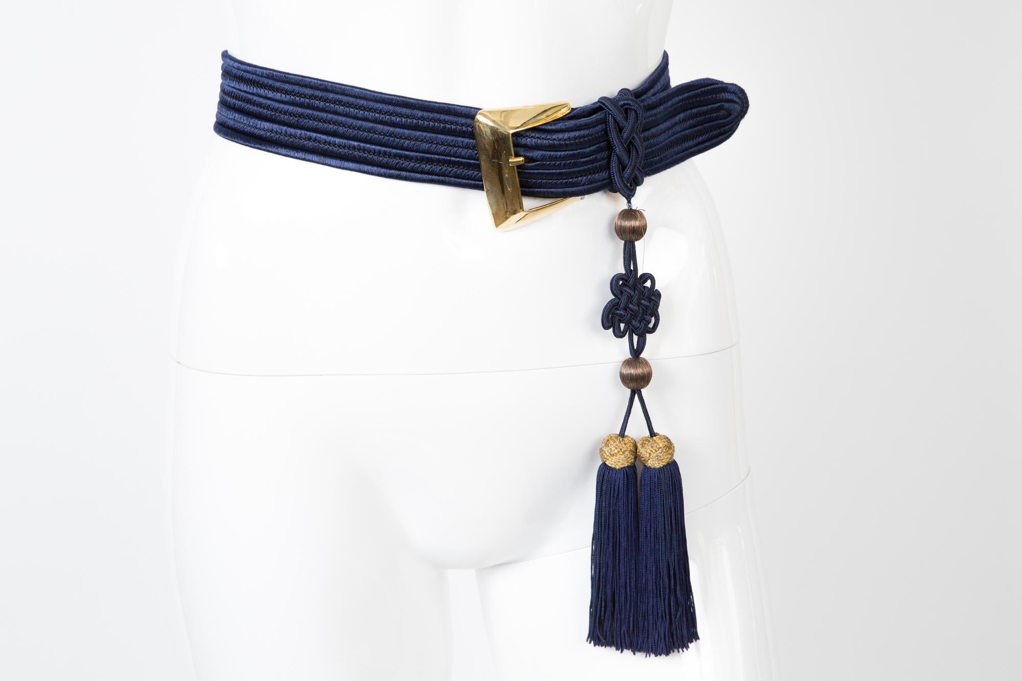 Blue Yves Saint Laurent braided belt featuring a fringed pompons, a gold tone buckle, logo gold tone metallic plaque. 
In excellent vintage condition. Made in France.  
Maxi Length 35in. (89 cm)
Width 1.5in. (4cm)
We guarantee you will receive this