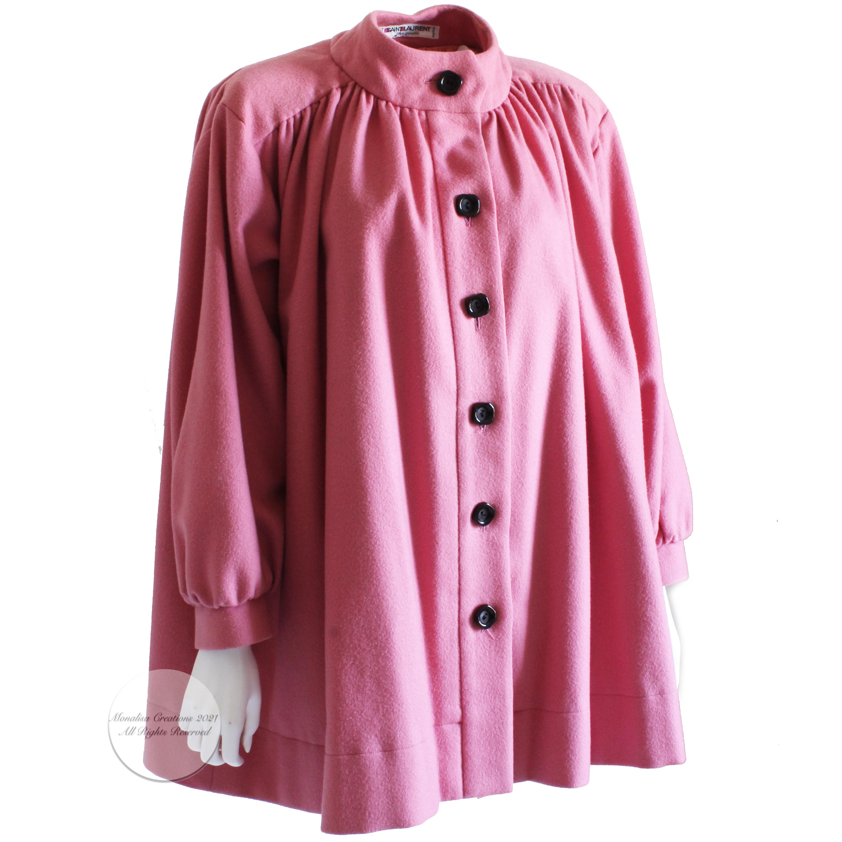Authentic, preowned, vintage Yves Saint Laurent peasant-style swing jacket or coat in pink wool, from S/S'85. Fully-lined, it features balloon sleeves and gathers at collar and back.  

Gorgeous pink wool coat and so hard to find nowadays.

Made in