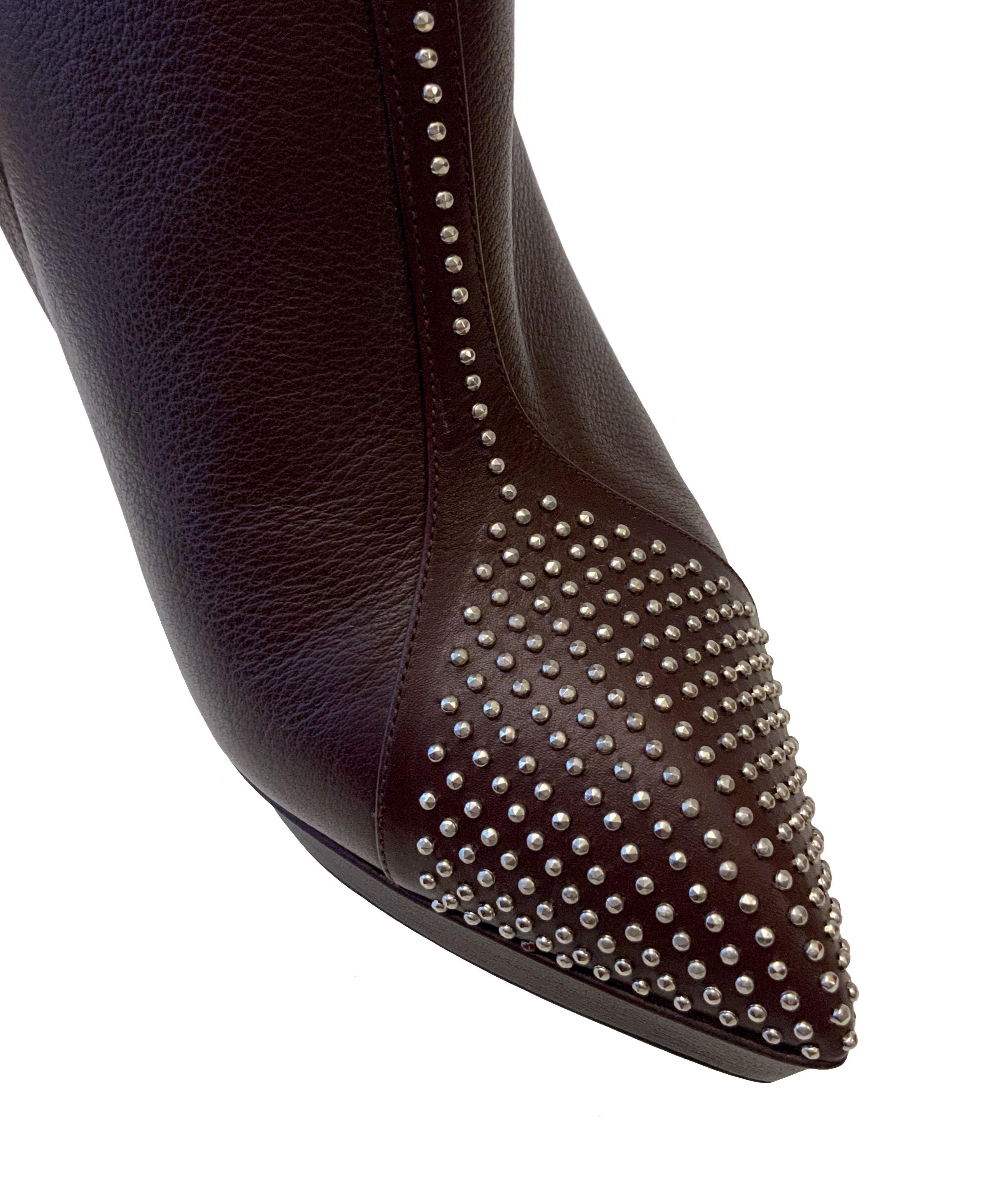This pre-owned calfskin ankle booties from Yves Saint Laurent feature micro stud embellishments on the toe cap, silver tone hardware.
 A black zippered closure and a non functional decorative buckle complete the boots.

Material: calfskin