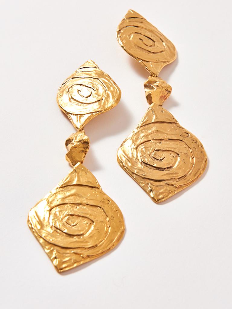 Yves Saint Laurent, gold tone, white metal, clip on, drop earrings having engraved spiral detail. These earrings
are super long and hit the shoulders.