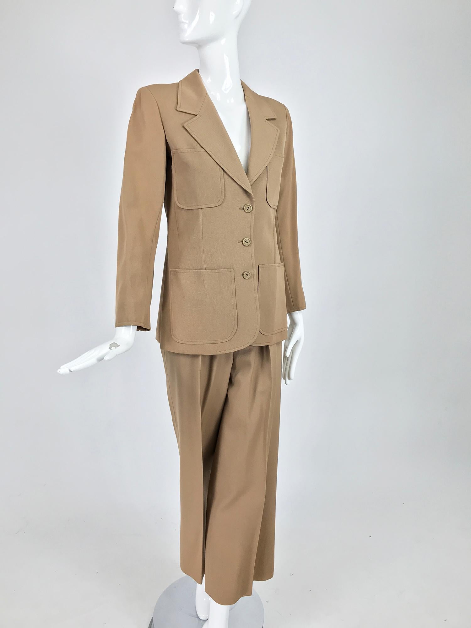 Yves Saint Laurent khaki tan wool twill 4 patch pocket pant suit from the 1970s. An early Rive Gauche pantsuit of flat wool twill, mid-light weight. The single breasted jacket closes at the front with buttons, there are 4 patch pockets, breast and