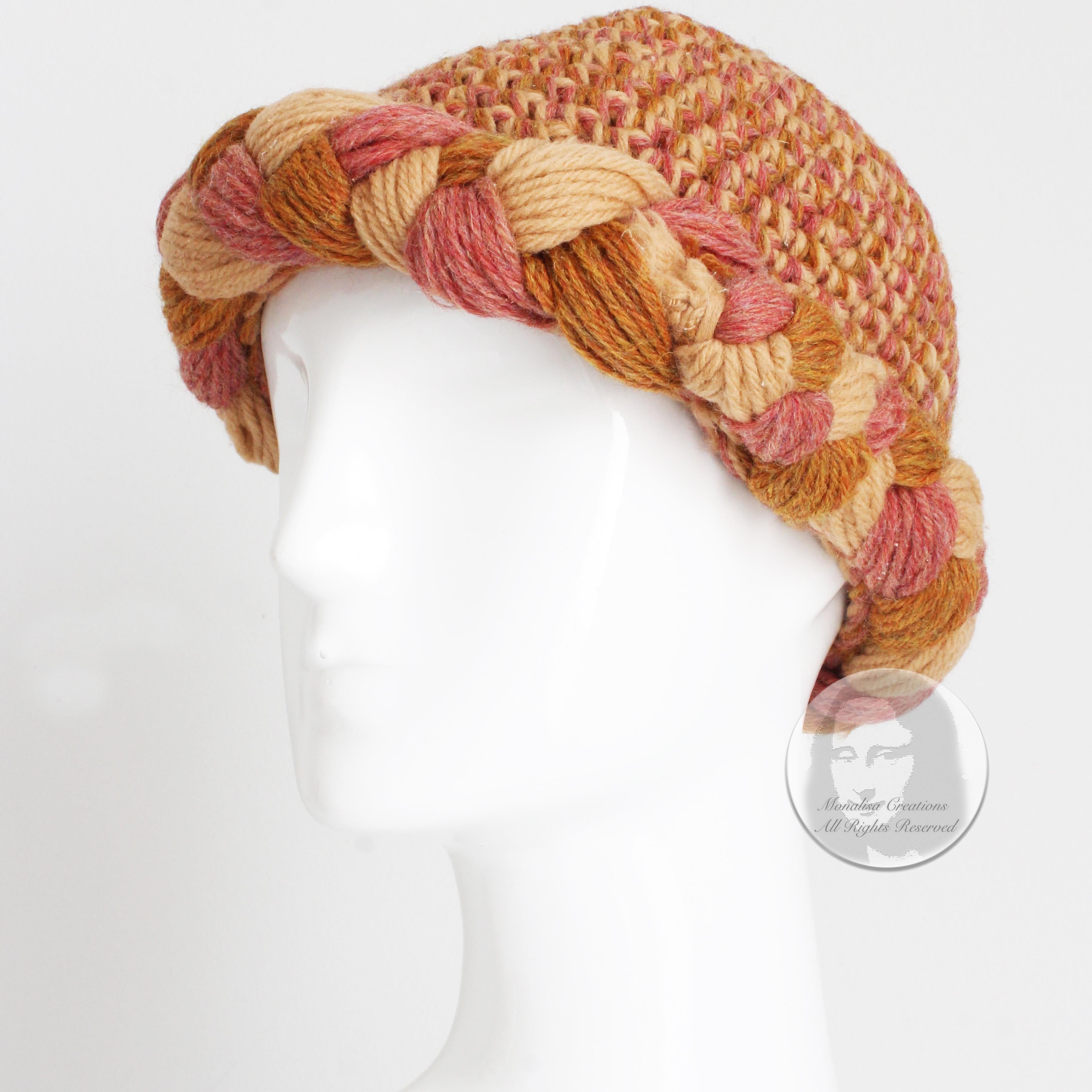 Fabulous vintage Yves Saint Laurent wool knit hat or cap with chunky braided border, likely made in the 1970s.

Made from multicolor wool yarn in shades of gold, pink, almond and melon, it features a thick braided border and is unlined inside. 