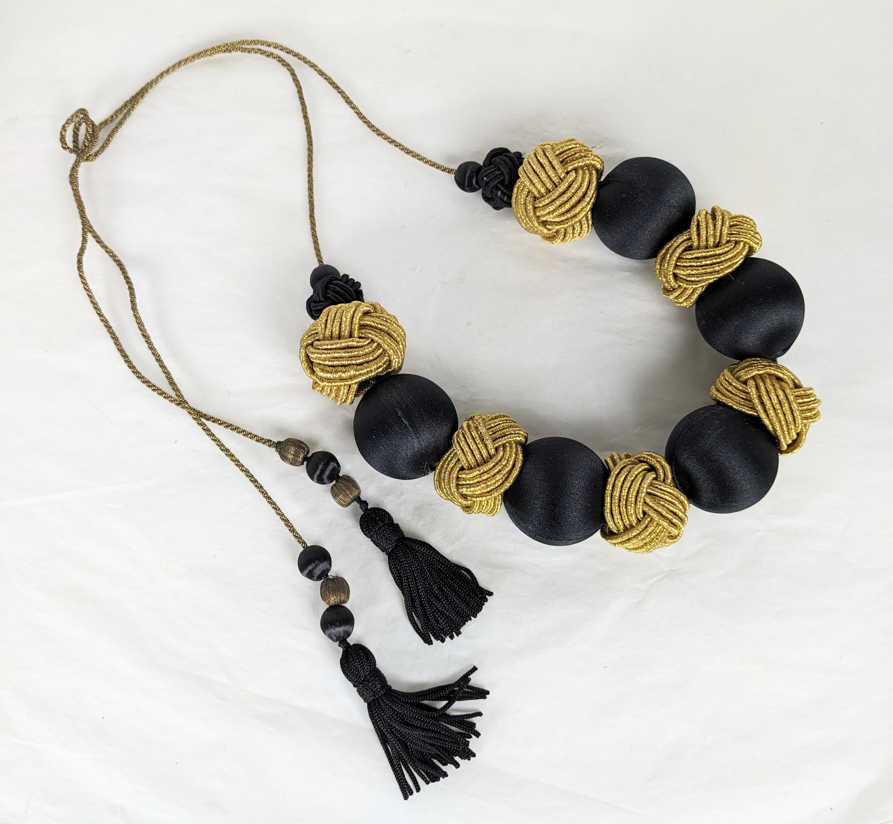 Yves Saint Laurent Passementerie Necklace, Haute Couture Fall/Winter 1977 Chinese Opium Collection. Composed of silk cord with tassel ends. Gilt chinese passementerie knots, silk sateen large and small beads imitating  black onyx. Excellent