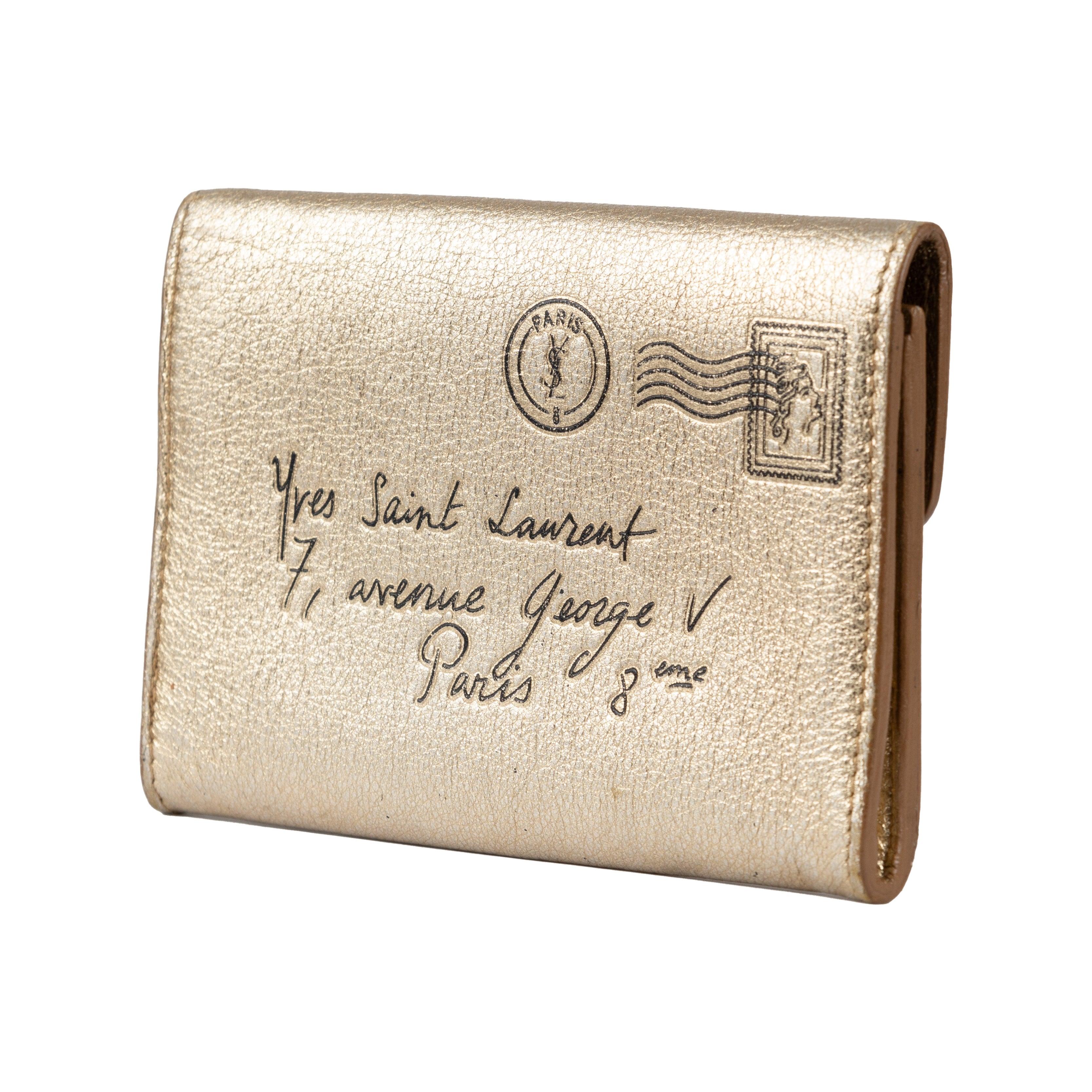 This Yves Saint Laurent Leather Card Holder is made from a luxurious metallic gold-tone leather and features tone stitching, gold-tone hardware, and one main compartment with an easy-to-use snap button closure. Crafted to provide durability and