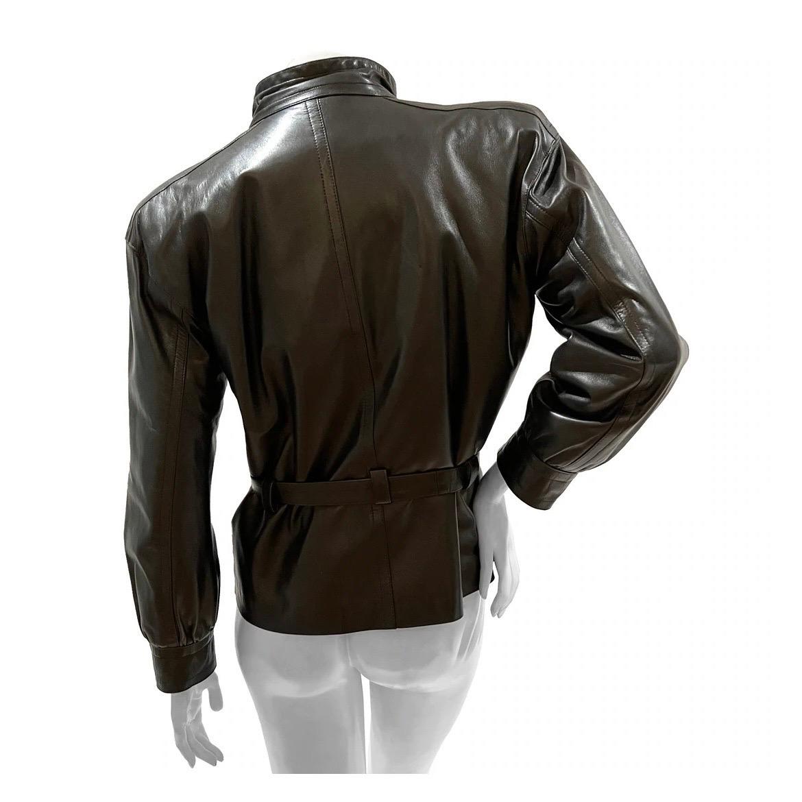 Yves Saint Laurent Fourrures Leather Coat 
Vintage 
Circa 1980's 
Made in France 
Chocolate brown leather 
Mock neck style collar 
Button at collar for closure 
Zipper down front of jacket 
Two flap pockets with round silver-tone button for closure