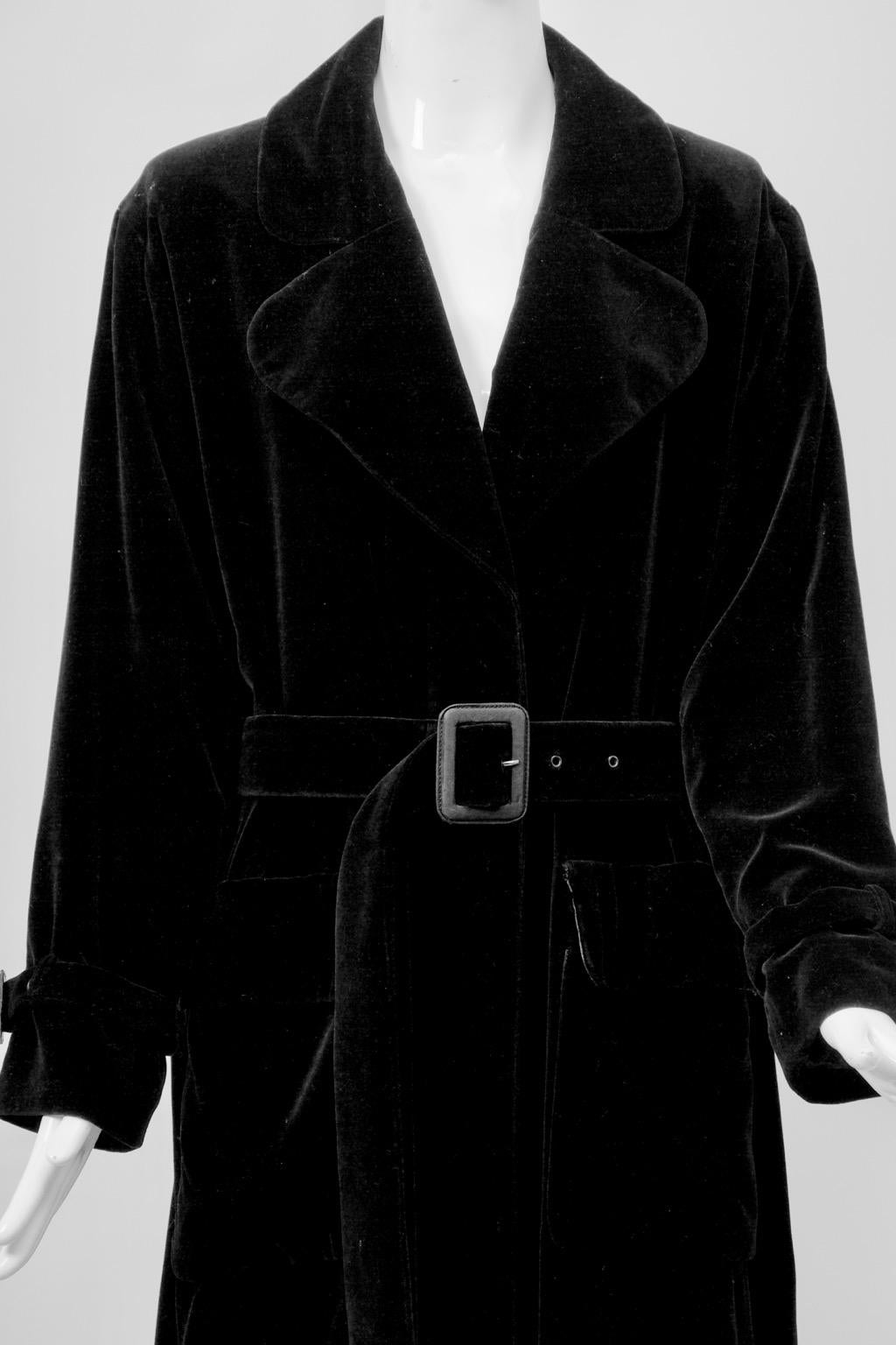 Yves Saint Laurent ankle-length trench coat with adjustable self belt and belted wrists. The coat features a wide notched collar and single-breasted closure with covered placket and open vent in back. Oversized cut. Black satin lining. Cotton blend