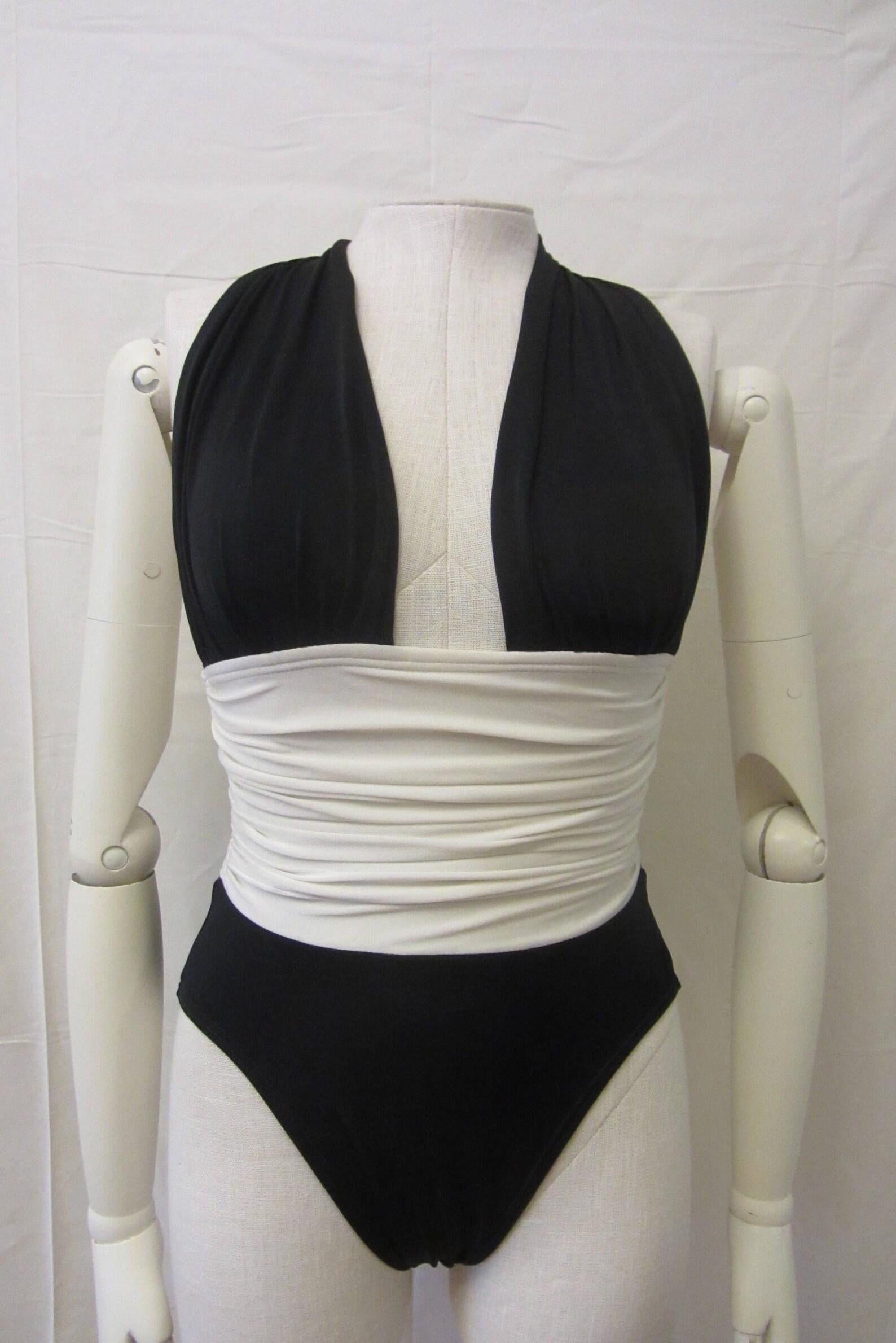 Gorgeous YSL one piece swimsuit!
Black and ivory white color blocking, plunging halter neck line, ruching at waist, high cut thigh, clasp closure at back neck.

A beautiful one piece from an Iconic Parisian Fashion House!

Circa Late 1970s/Early
