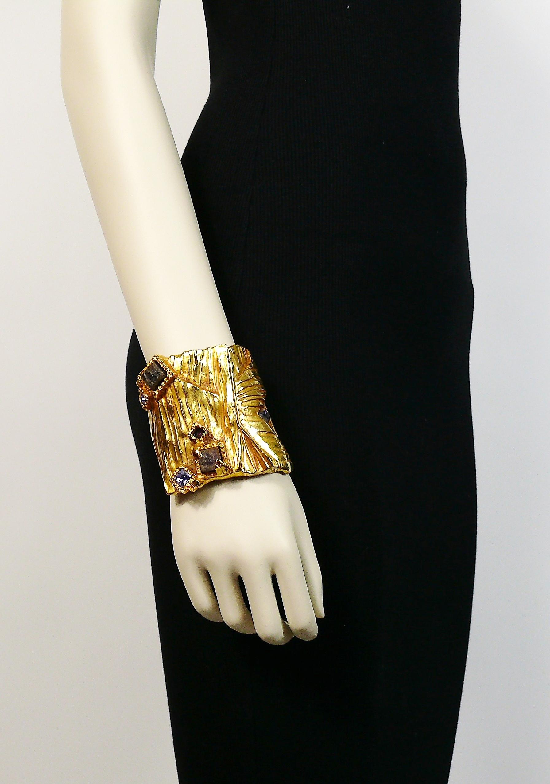 YVES SAINT LAURENT massive ARTY textured gold tone cuff bracelet embellished with hard stones, crystal and enamel. Stylized Y initial.

Embossed YVES SAINT LAURENT.

Has weight on it (approx. 300 grams).

Indicative measurements : inner max. width