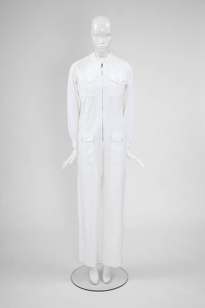 Famous 70’s YSL mechanic uniform inspired jumpsuit. Constructed in white cotton, this very rare piece features a long industrial zipper front closure which allows to be, depending of the mood, more or less feminine (see picture 7). Two large flap