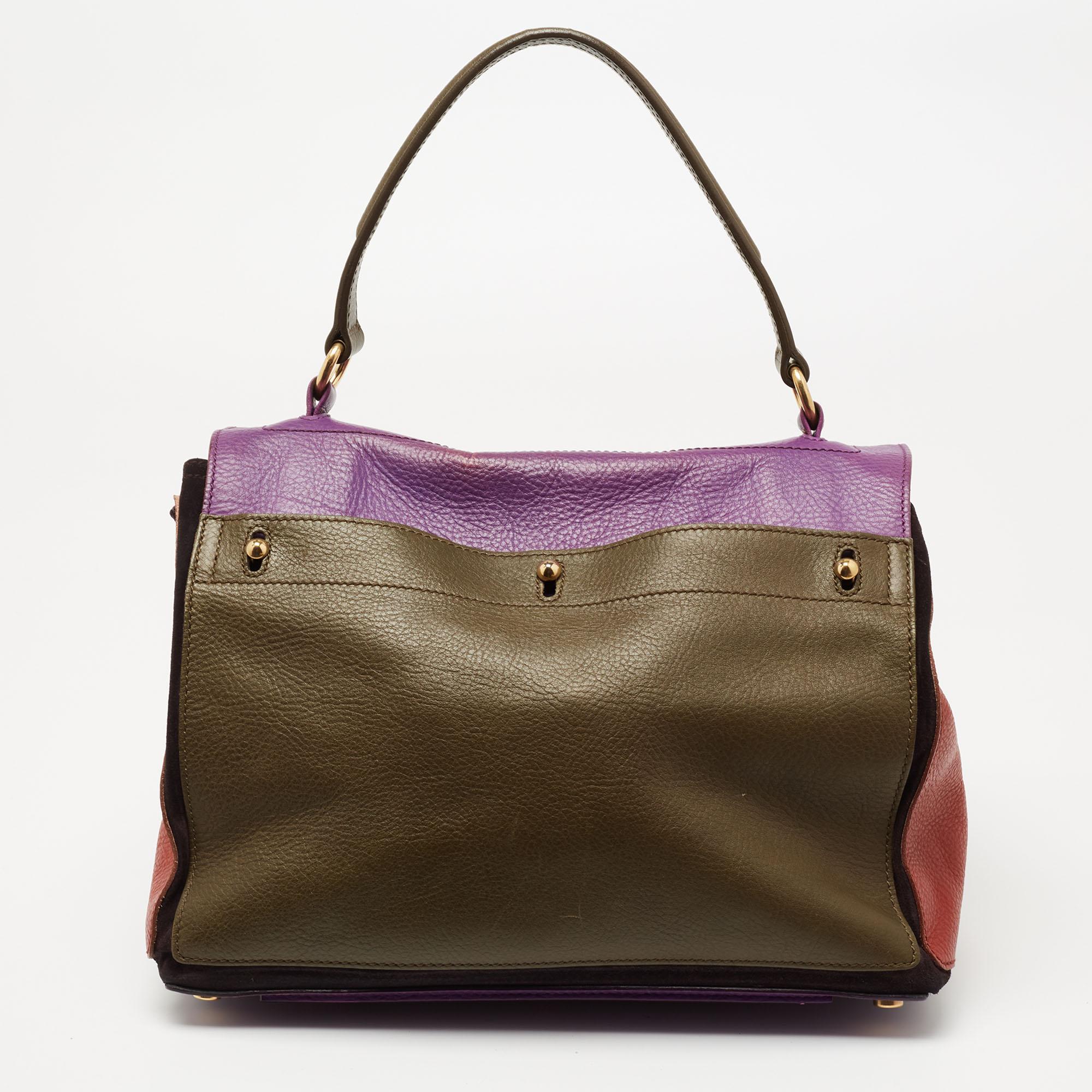 This Yves Saint Laurent Muse Two bag is perfect for everyday use. It has an exterior meticulously crafted from leather and suede. The multicolored bag has a top handle and gold-tone details. The flap closure opens to a roomy canvas-lined
