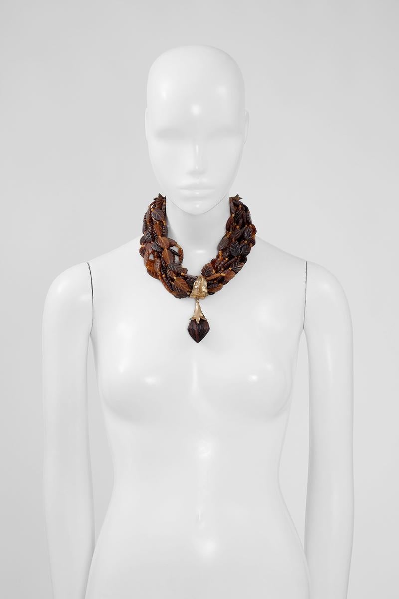 Yves Saint Laurent's jewellery was regularly inspired by the beauty of nature. This vintage statement necklace is cast from gold-tone brass and features multi strands of resin beads and leaves. Refined different hues of brown which recalls perfectly