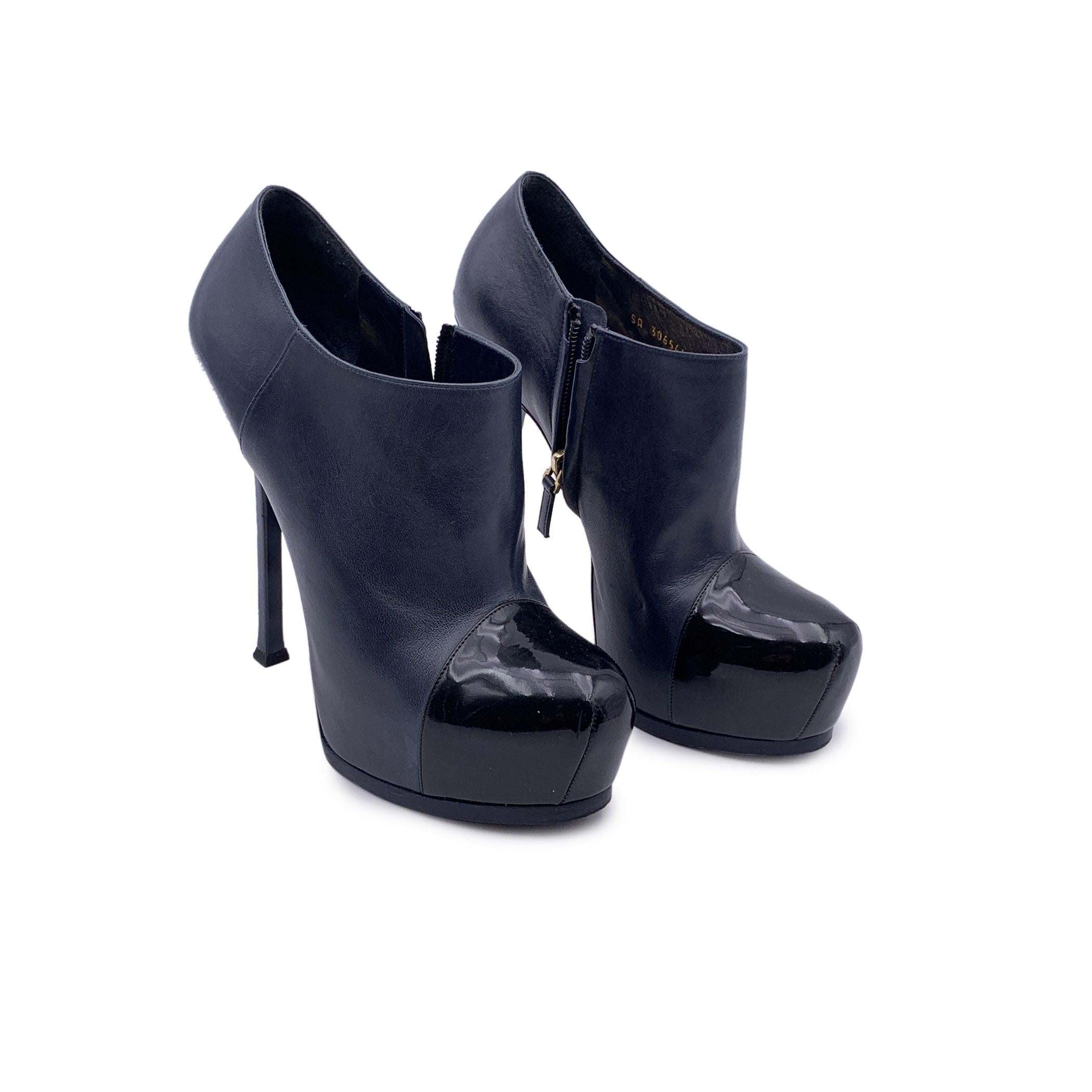 Yves Saint Laurent Tribtoo ankle boots , crafted of navy blue leather with a black patent leather cap toe. These booties feature round toe, hidden platform, stiletto heels. Side zip closure. Heels Height: 5.9 inches - 15 cm. Platform height: 1.5