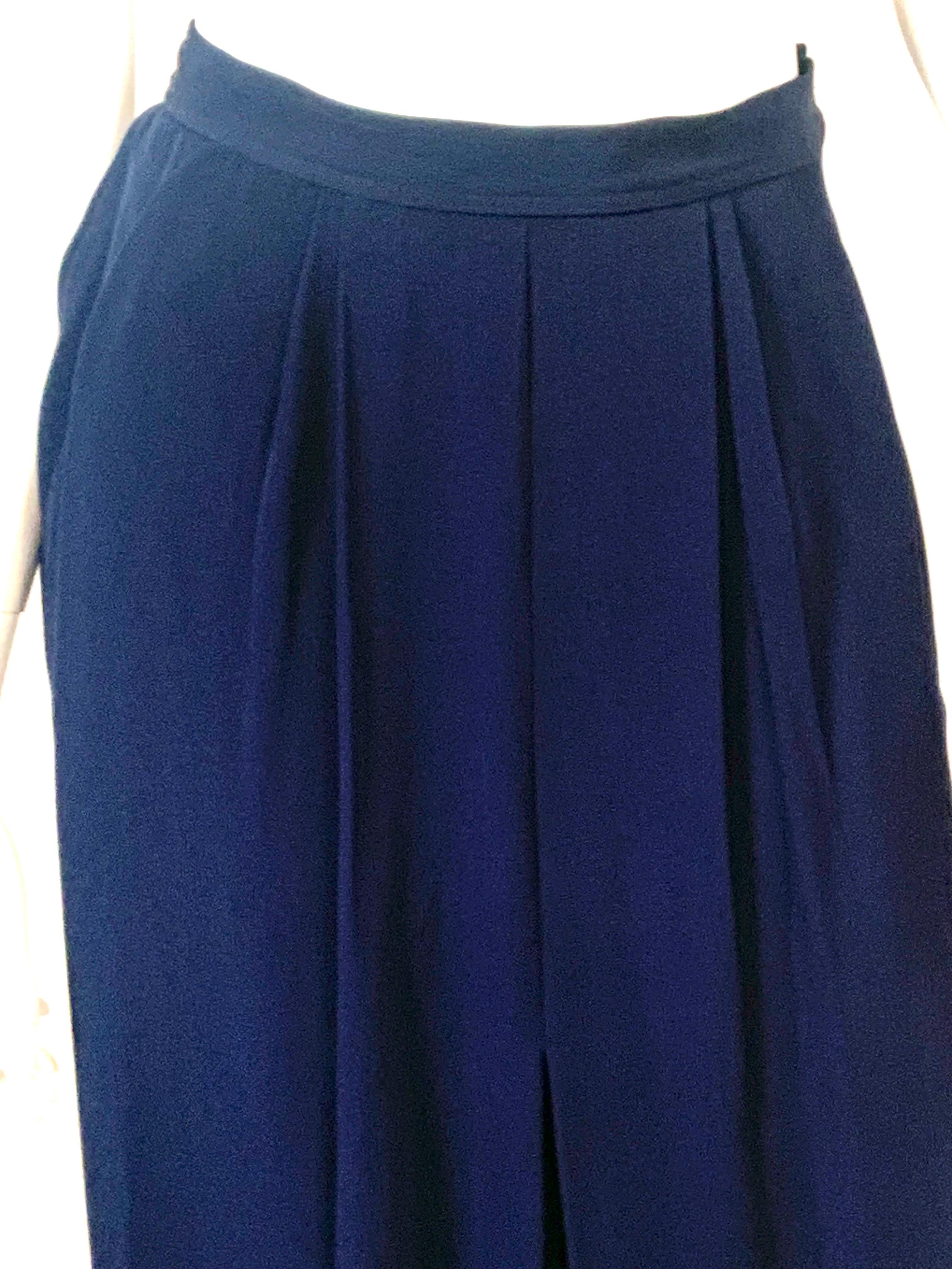 This Yves Saint Laurent Rive Gauche long skirt still retains the original tags, attached to the label. Never worn, it is in pristine condition. There are loose pleats at the center front, pockets in the side seams and soft gathers at the back.  This