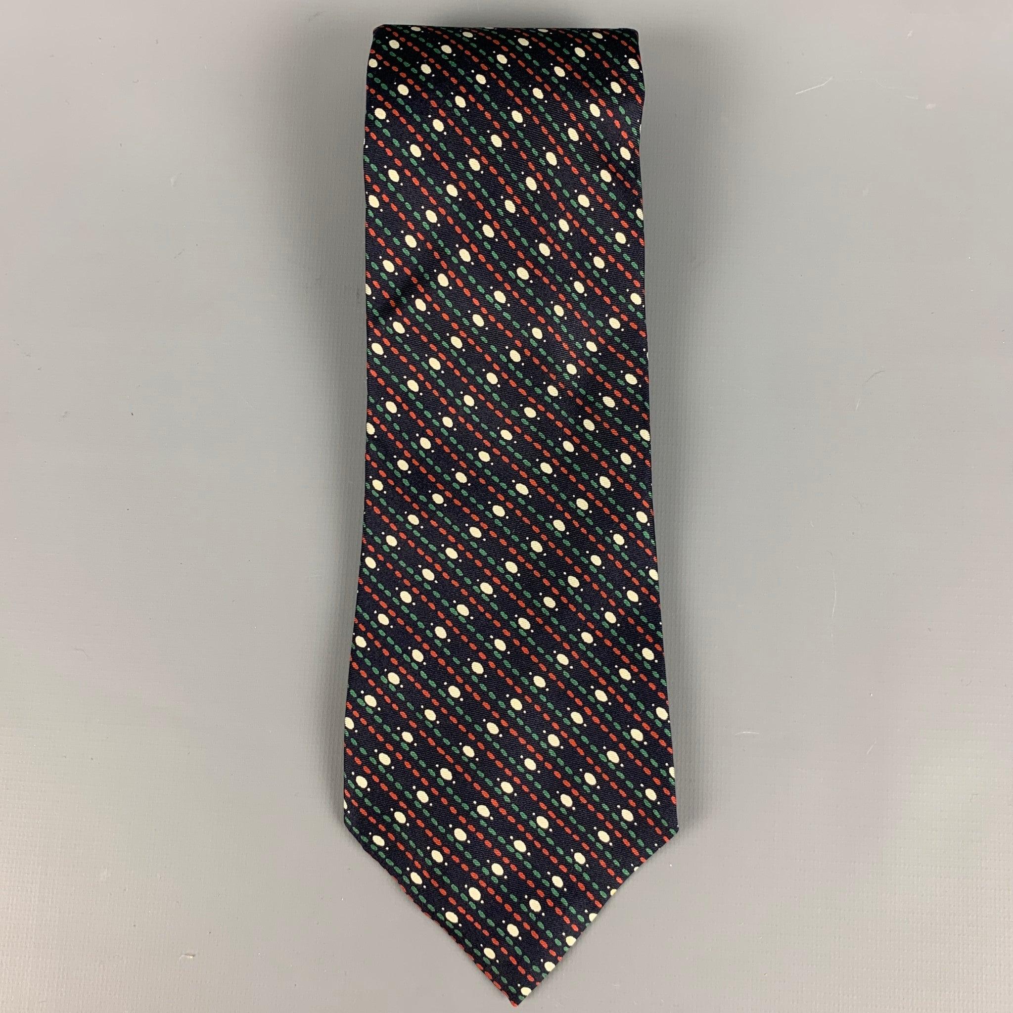 YVES SAINT LAURENT
necktie in a
navy silk fabric featuring a red, green, and white striped dots pattern. 
Very Good Pre-Owned Condition. Minor signs of wear. 

Measurements: 
  Width: 3.5 inches Length: 54 inches 
  
  
 
Reference: 127793
Category: