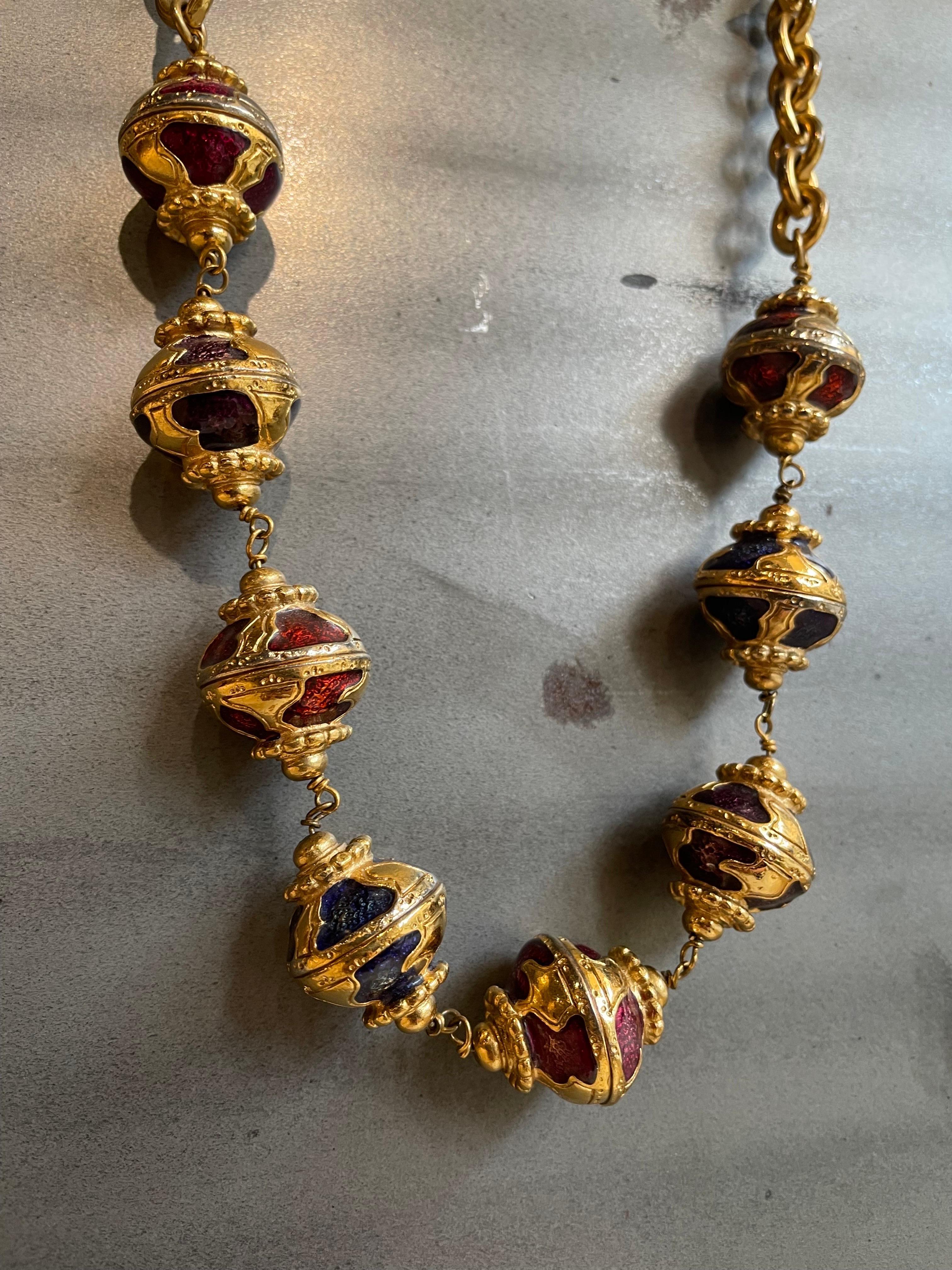Yves Saint Laurent necklace year 1976 Russian period. Made of gilded metal with enamelled charms in various colours. 
Adjustable closure on 3 different lengths. Held very well only in some places, the gilding has faded as you can see from the