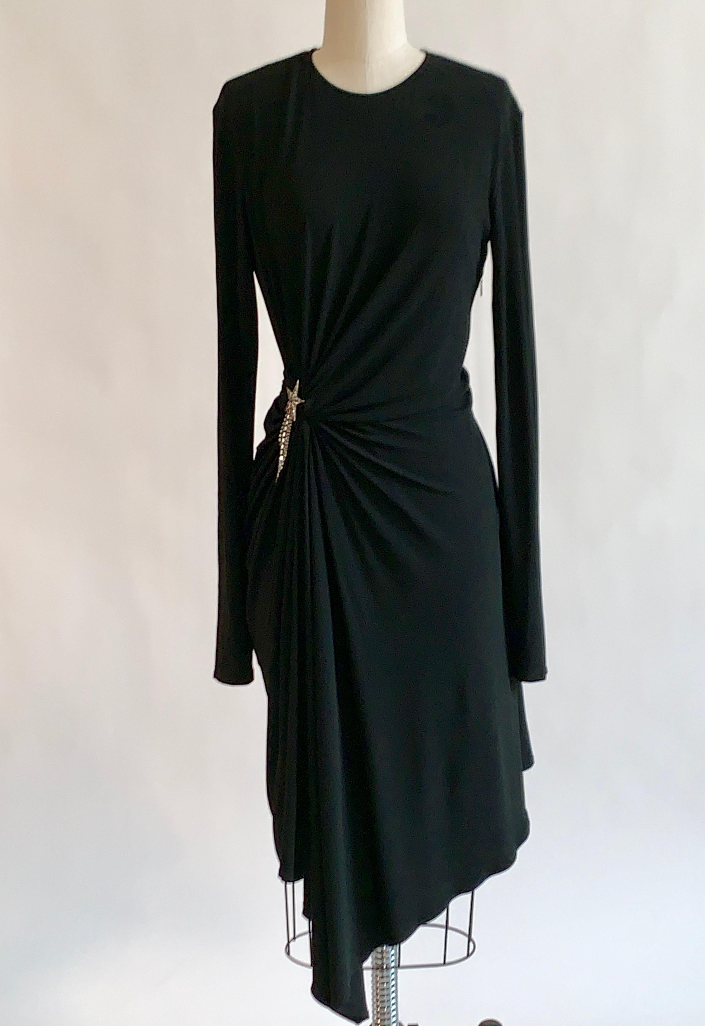 Yves Saint Laurent 2017 black dress with silver tone star embellishment and gathering at side. Longer sleeve length so they can look pushed up, even when worn to wrist.  Round collar and long sleeves. Keyhole with button closure at back neckline,