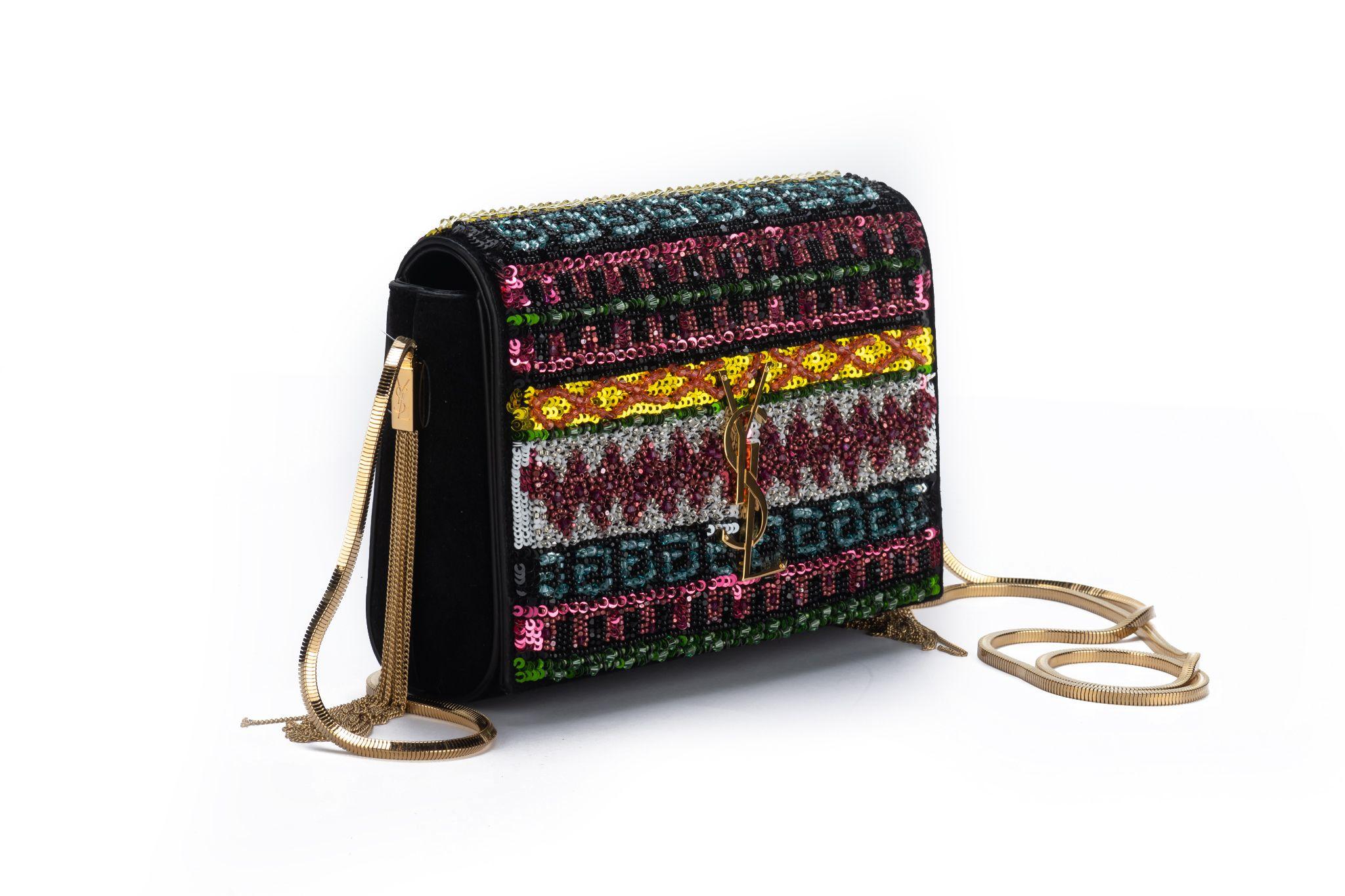 Yves Saint Laurent brand new black suede cross body bag with multicolor seabeads, gold chain and side tassels . Shoulder drop 21”. Comes with original dust cover.