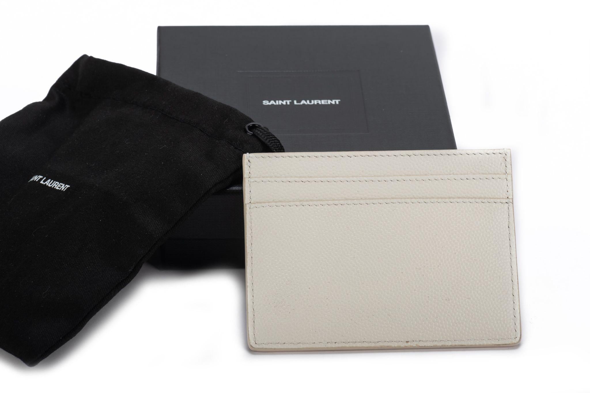 Yves Saint Laurent brand new white pebbled leather credit card case. Comes with booklet, original dust cover and box.