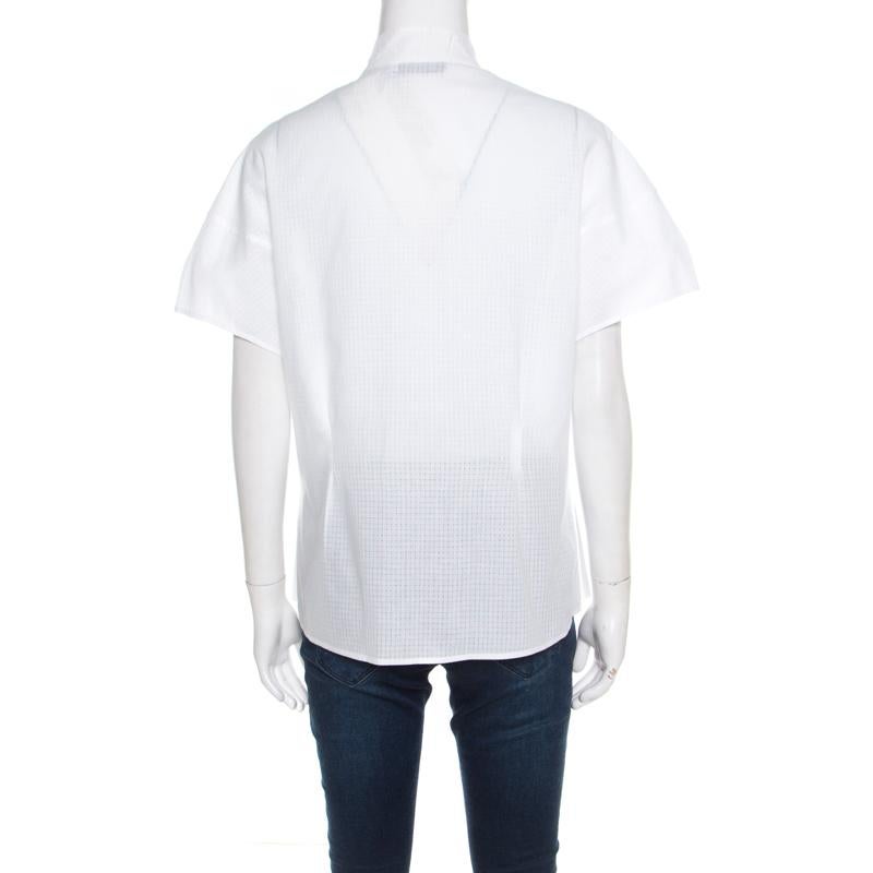 Stylish and modern, this shirt from Yves Saint Laurent is sure to capture your attention. Made of 100% cotton, it features a tie detail on the neckline. It flaunts front button fastenings and short sleeves.

Includes: The Luxury Closet Packaging

