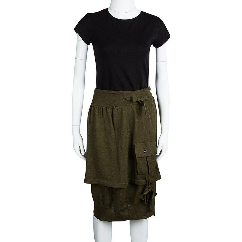 YSL’s skirt is high on the ‘military garb’ trend. The olive green skirt has a layered front with a baggy pocket on the side, ribbed- broad waistband, and a self- fabric cord tie-up at the waist. Keep warm in this woolen blend skirt and it with your