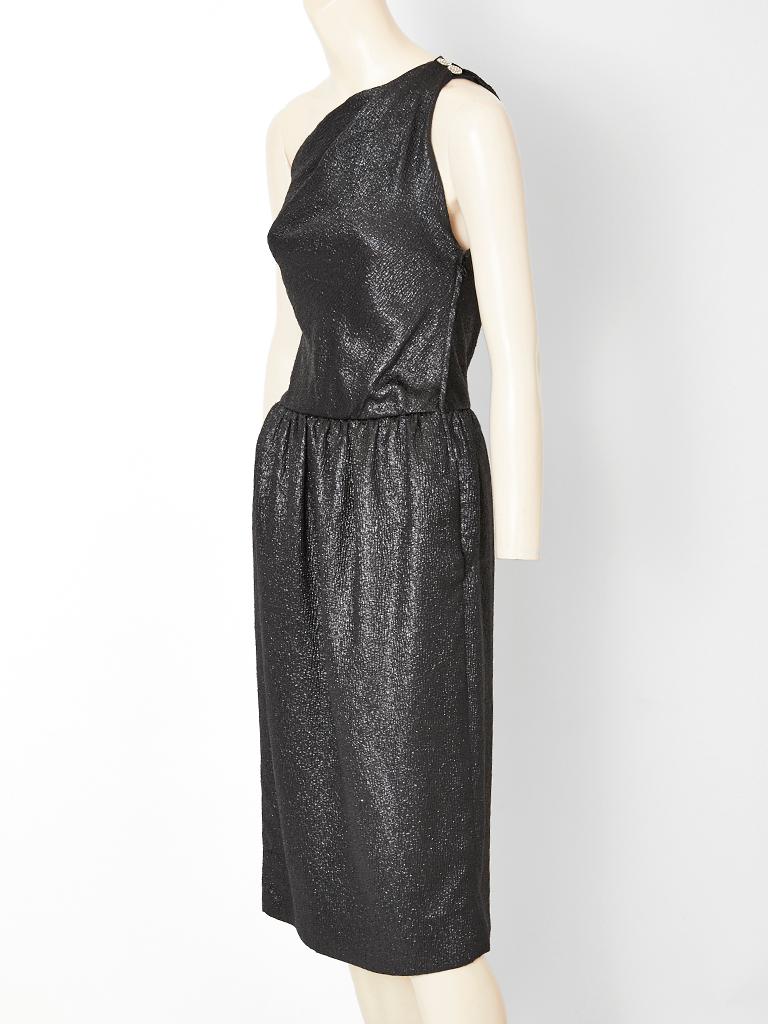 Yves Saint Laurent, Rive Gauche, black metallic, silk cloqué, one shoulder cocktail dress having a subtle shimmer, fitted bodice, a gathered skirt,  and a side zipper  closure.
