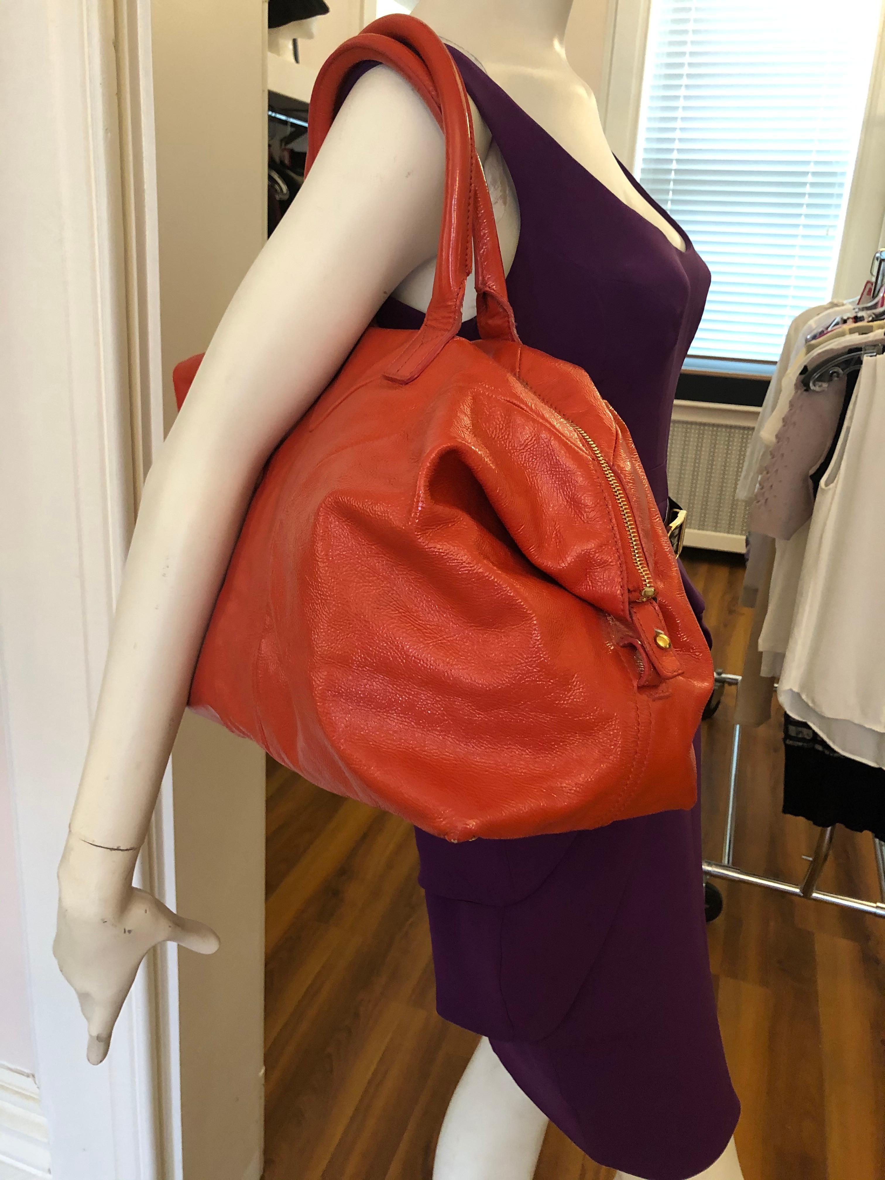 This is a nice size bag with gold tone hardware, and two ways to use as per pictures.
The bag is in very good condition, with a zipped closure; one zipped pocket on the lining, and two smaller open pockets, also on the lining.
The serial# is