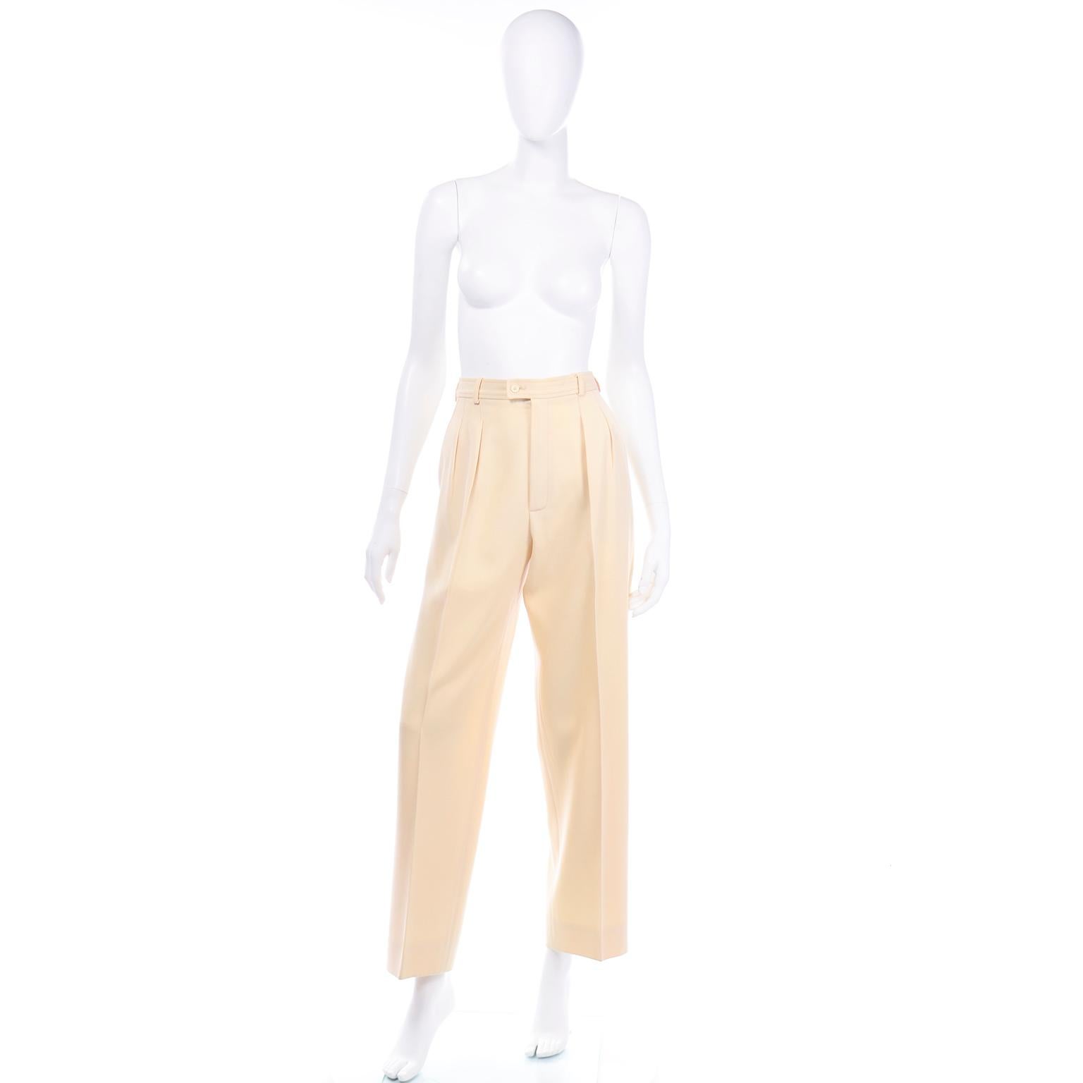 These vintage Yves Saint Laurent Rive Gauche cream pants are a spring staple! The color is a perfect neutral banana cream. These pants have a medium weight wool feel, so they will be great as a transitional piece from winter to spring. The front of