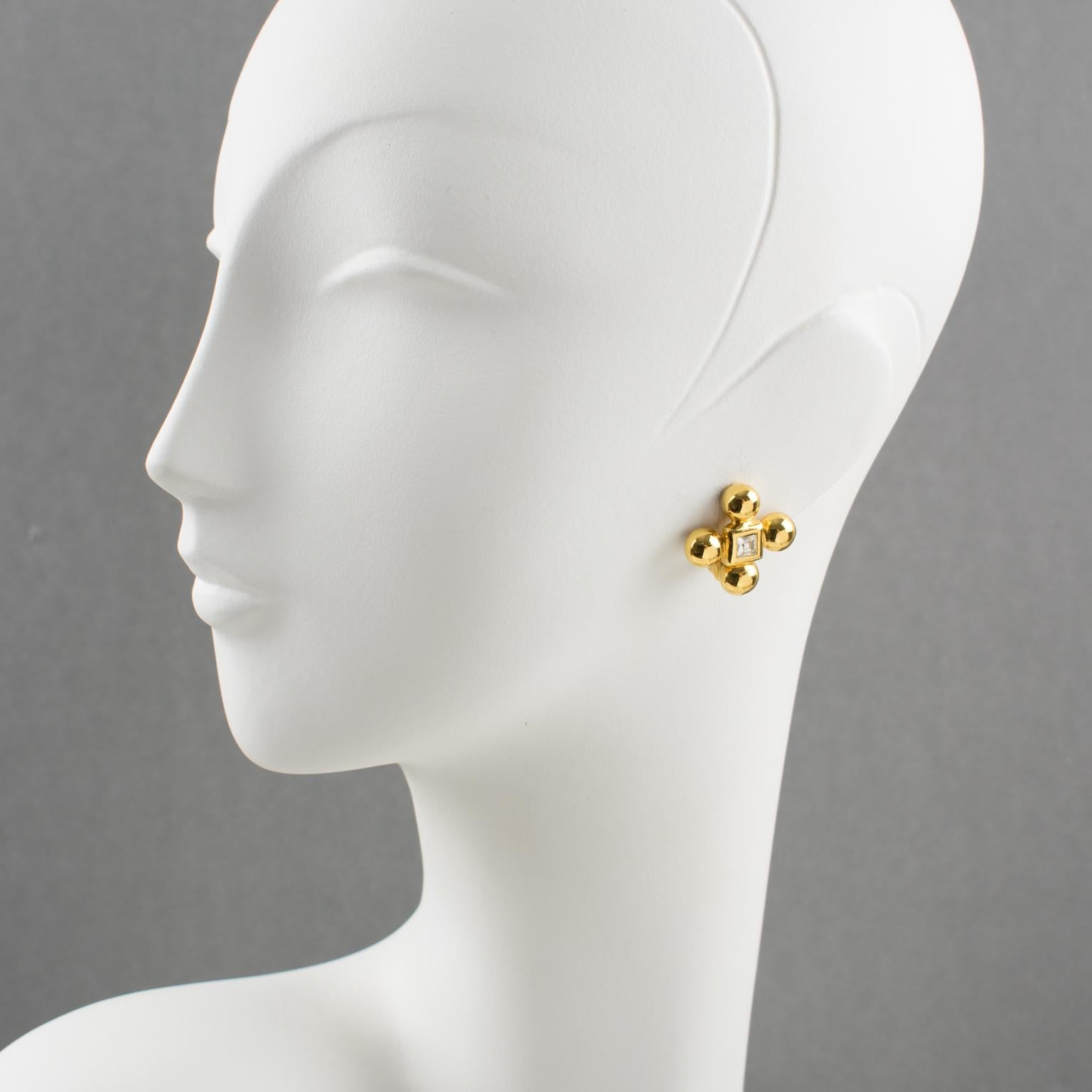 Elegant Yves Saint Laurent YSL Paris signed clip on earrings. Modernist 4 clover shape, shiny gilt metal frame topped with square crystal clear glass rhinestone. Signed at the back with YSL pierced logo on clip and engraved underside: 
