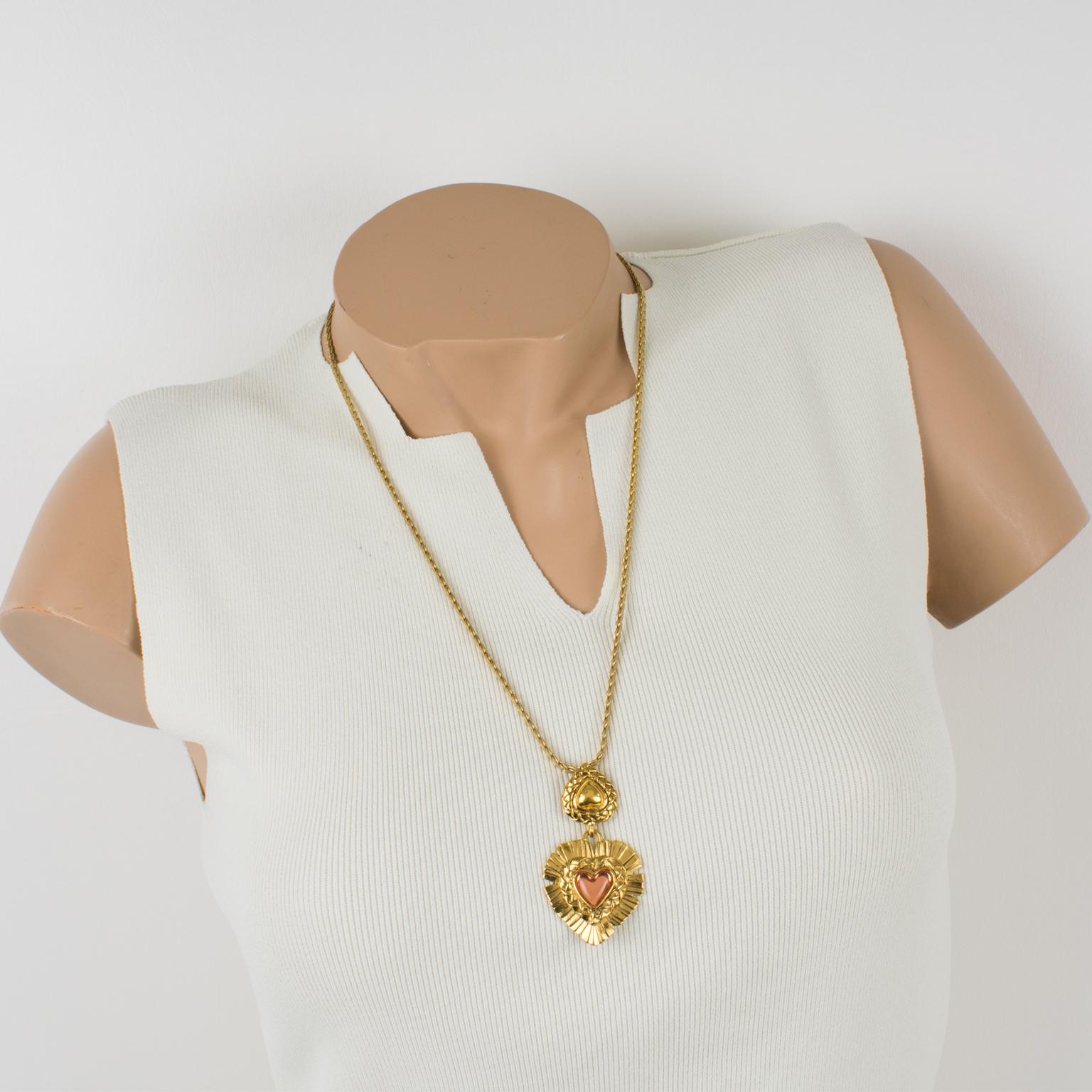 Fabulous Yves Saint Laurent Paris pendant necklace. Featuring a long gilt metal link chain and heart-shaped pendant. The pendant is in gilt metal all textured and ornate with a lovely pink resin heart cabochon. 