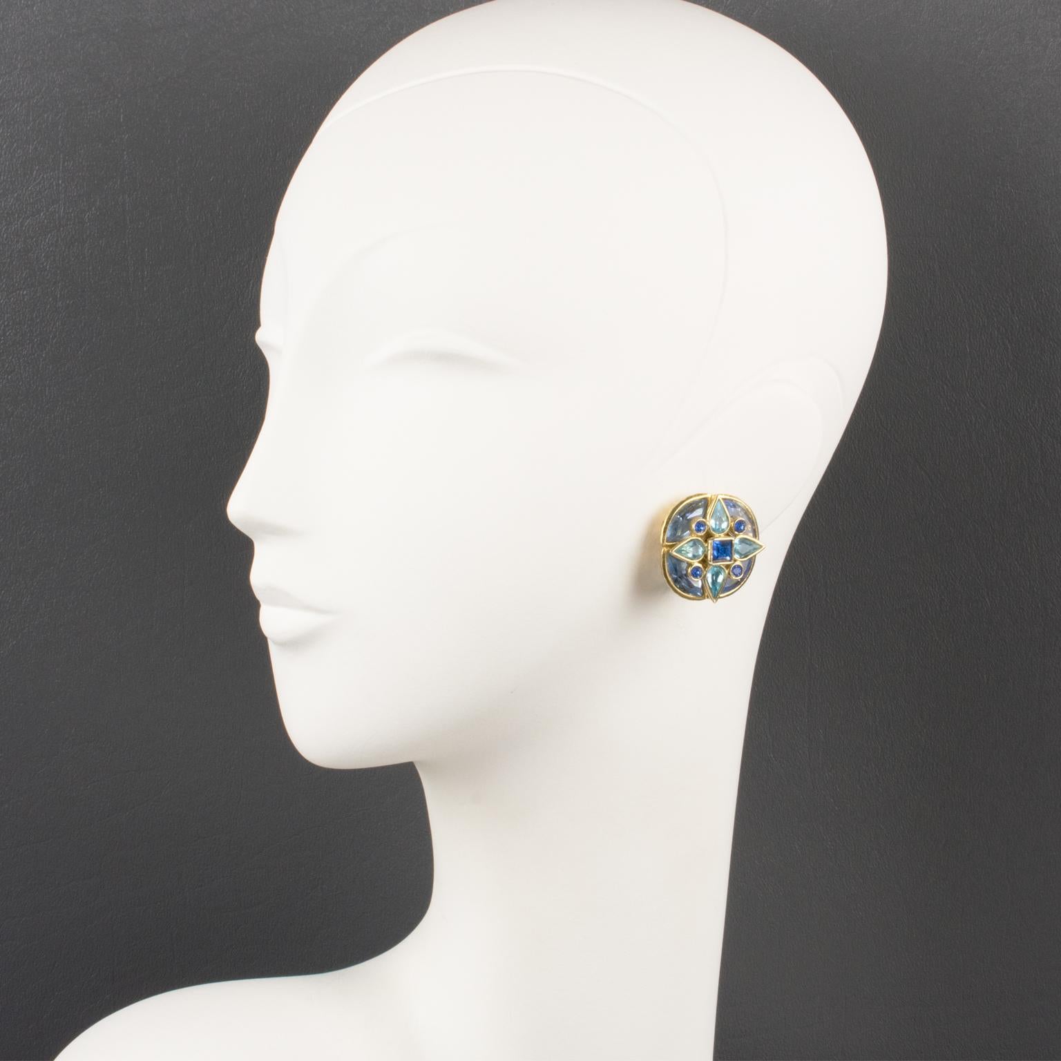 Gorgeous Yves Saint Laurent Paris floral clip-on earrings. Gilt metal flower framing topped with crystal rhinestones in assorted shape and colors. Blue range tones in baby blue, bright blue, and lavender blue. Engraved marking on fastenings: 