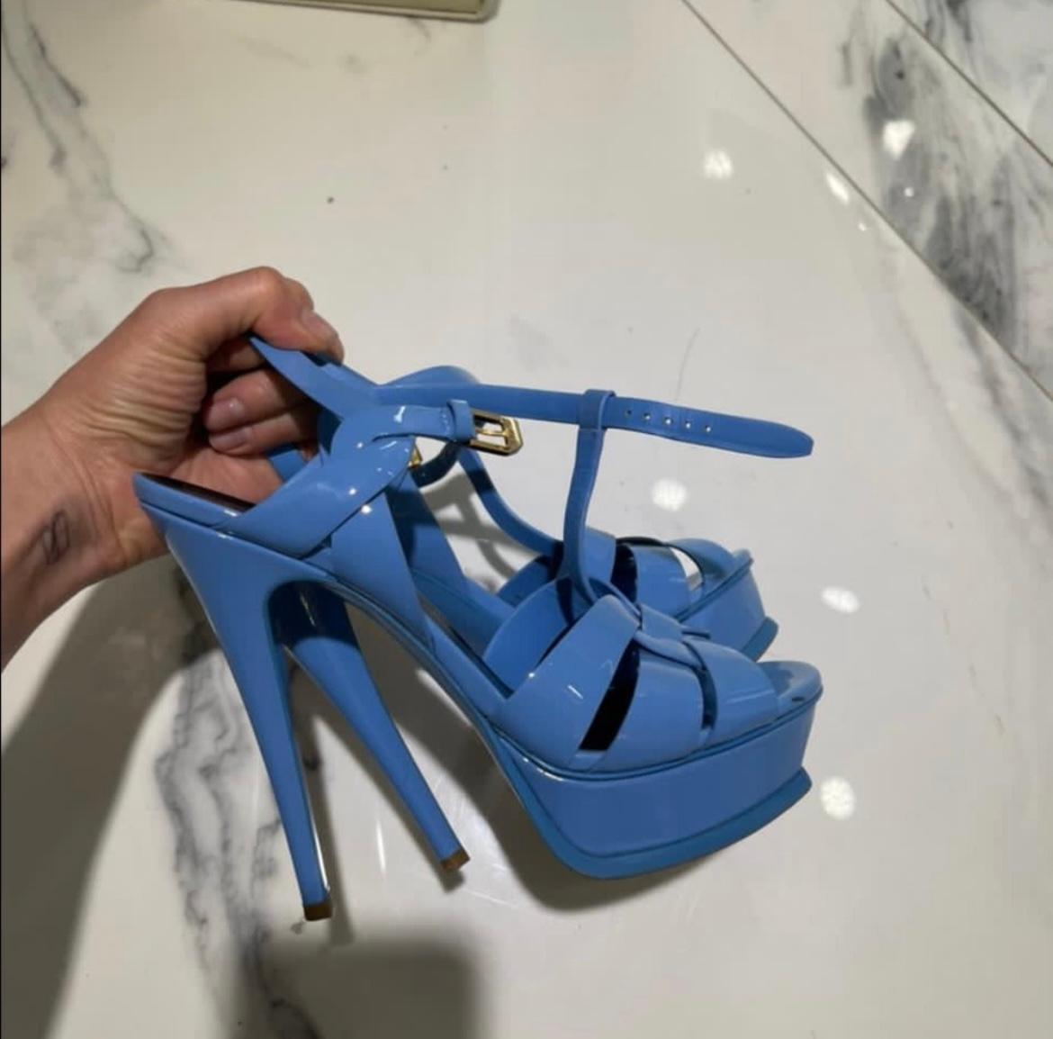 Diese Plateausandalen von YSL sind sexy und stilvoll. Diese atemberaubenden Absätze sind aus Lackleder, haben eine 1-Zoll-Plateausohle, eine offene Schnalle vorne und einen umlaufenden Knöchelriemen, der für Stil und Komfort sorgt. 
Die Sohlen