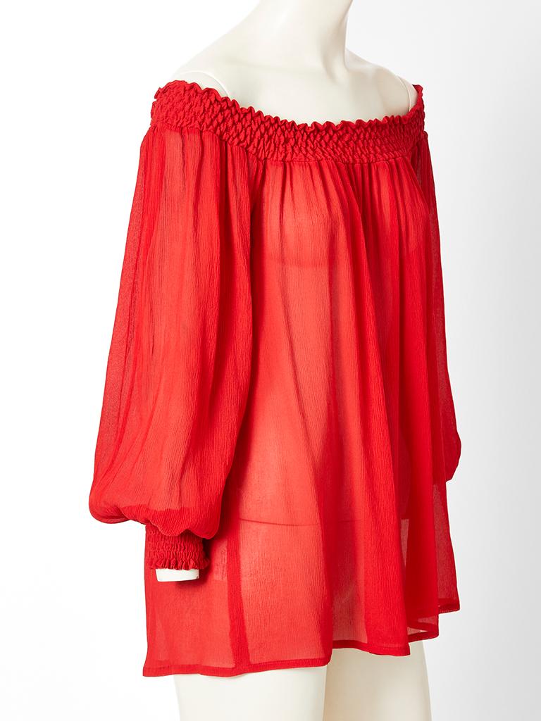 Yves Saint Laurent, Rive Gauche, red, lightweight, crinkle silk, peasant style, blouse having smocking at the neckline and wrists.