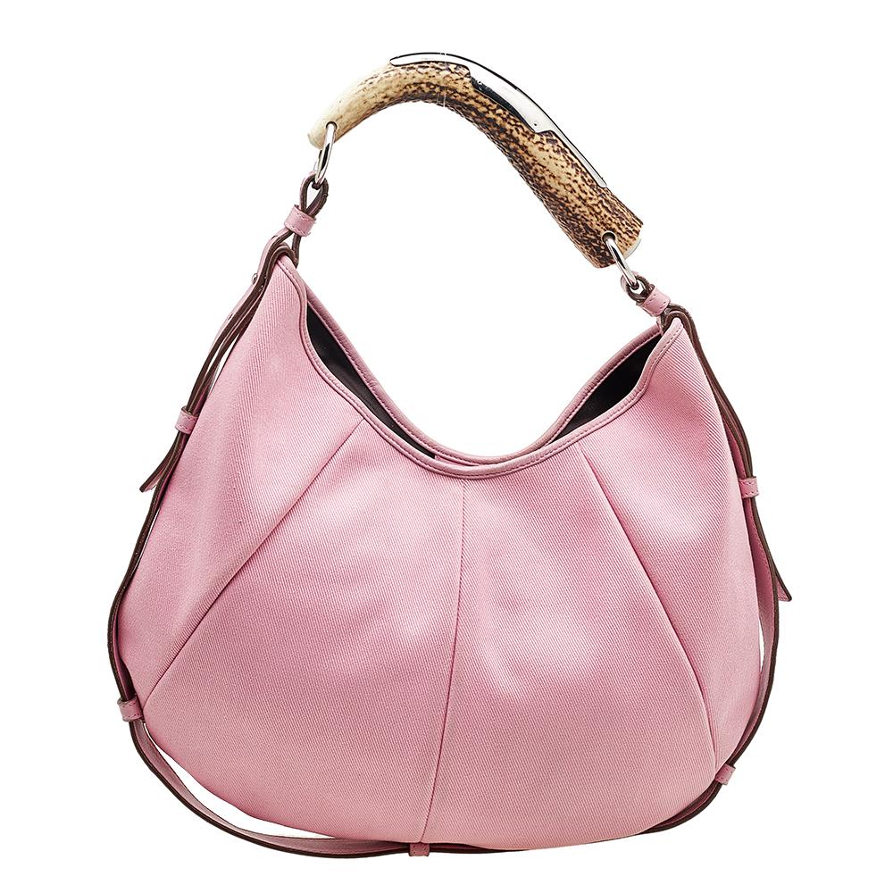 You will love to have this Yves Saint Laurent Mombasa hobo. Crafted from pink canvas as well as leather and held by a unique handle, the bag is a beauty. The interior is lined with fabric and sized to house your essentials with ease.
