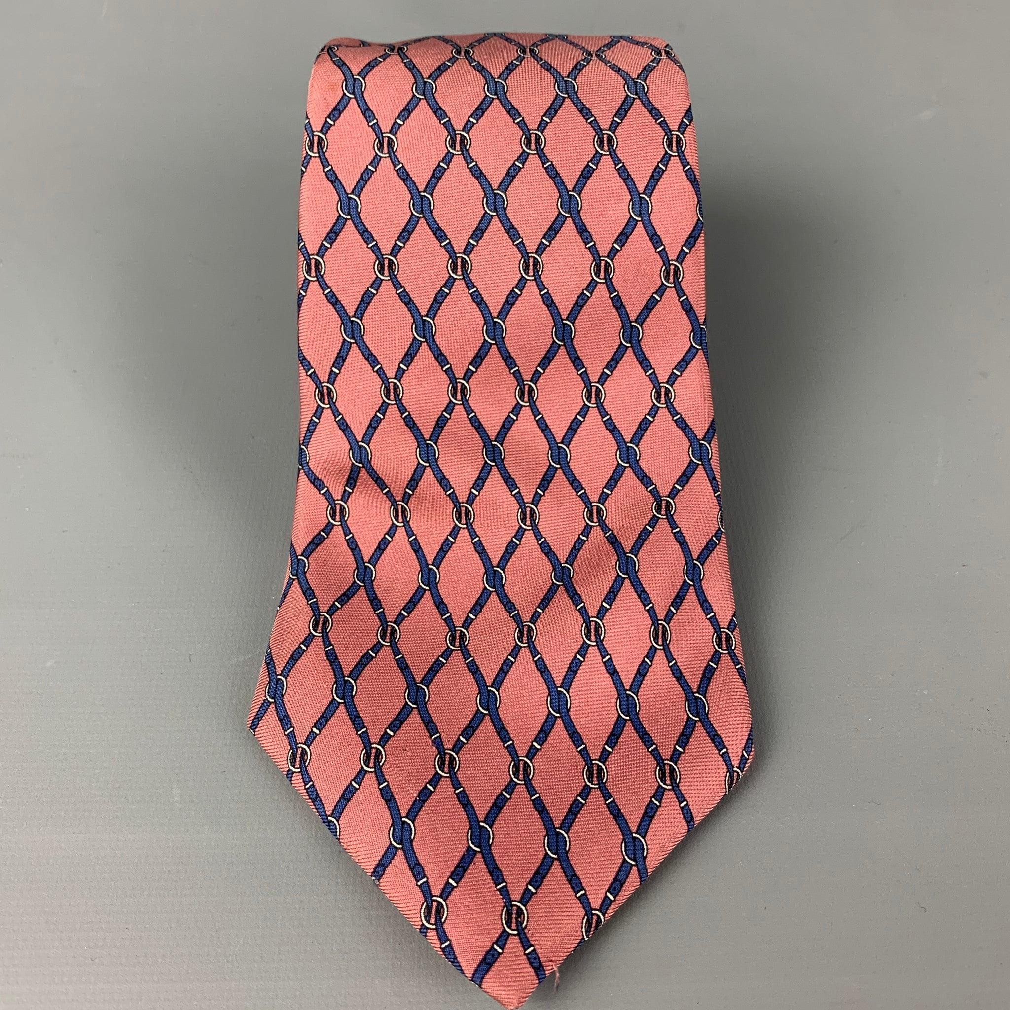 YVES SAINT LAURENT
 necktie comes in a pink &
 navy silk with a all over equestrian print. Made in USA. Very Good Pre-Owned Condition.Width: 3.75 inches 
  
  
  
 Sui Generis Reference: 118095
 Category: Tie
 More Details
  
 Brand: YVES SAINT