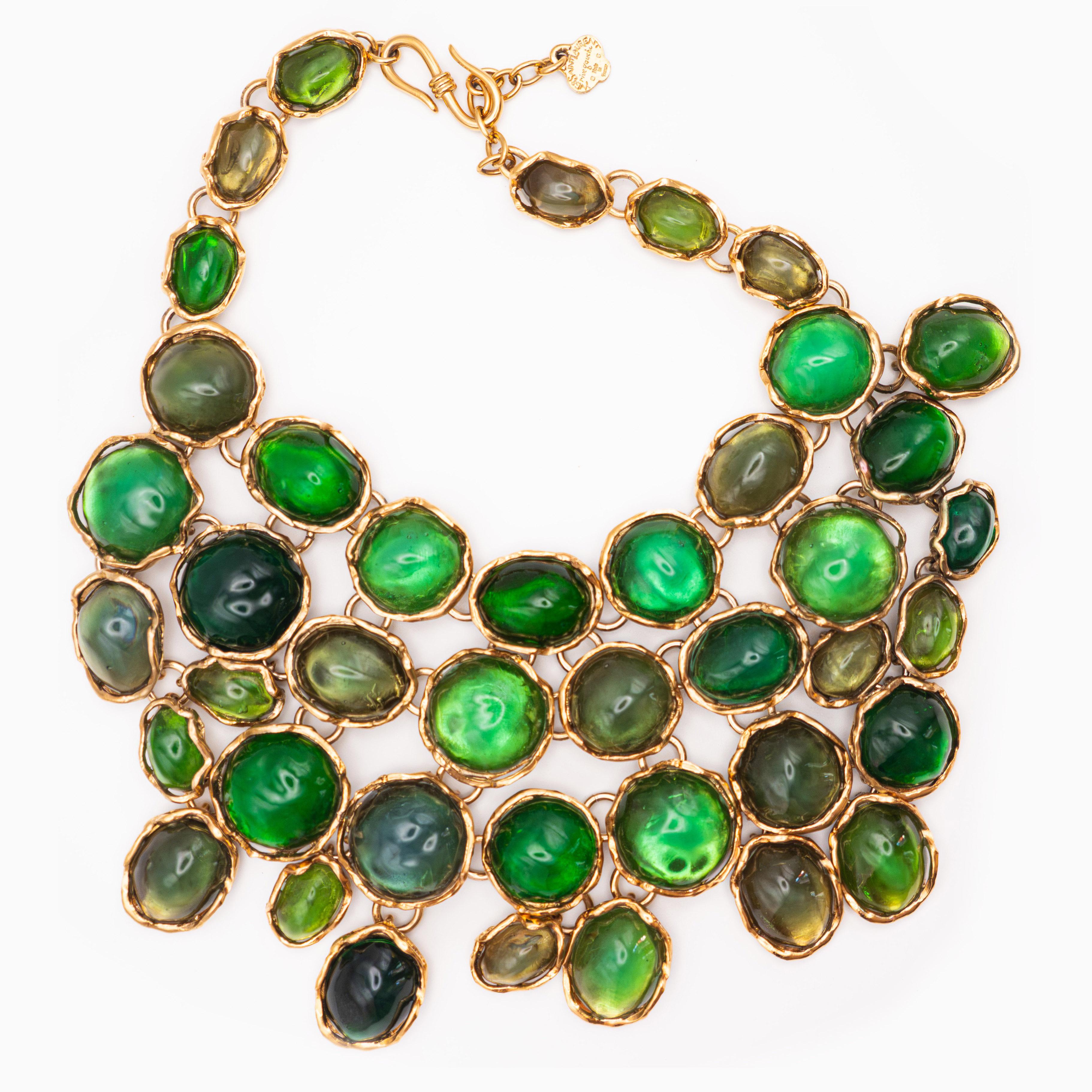 Yves Saint Laurent Gemstone Necklace by Loulou de la Falaise and Goossens from 1989. Dramatic oversized cast glass necklace with huge resin gemstones in gilt bronze. Adjustable hook closure.
23 cm