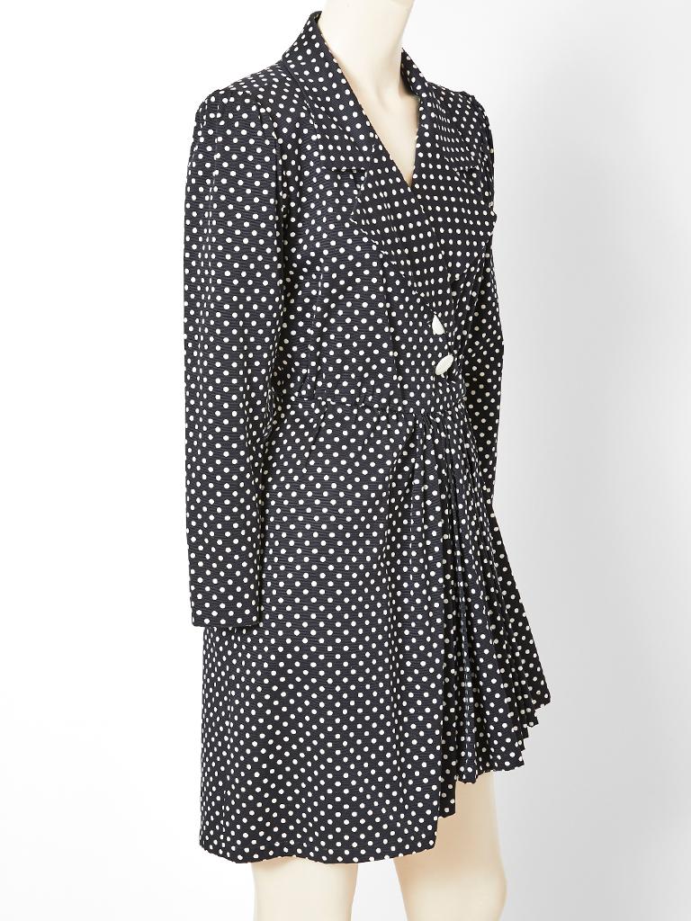 Yves Saint Laurent,  rive gauche, heavy cotton faille, black and white polka dot wrap dress having a wide lapel notched collar with a fitted bodice. Skirt is sarong like  with a draped asymmetric  panel that fastens at the hip.