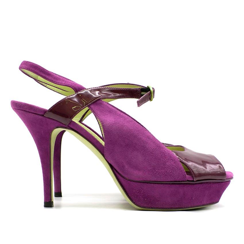 Yves Saint Laurent Purple Peep-toe Heeled Sandals
 
 - Purple suede and patent leather heeled sandals
 - Peep-toe
 - Front buckle fastening
 - 105cm stiletto heel
 - Nude leather lining with logo embossed
 - This item comes with the original dust