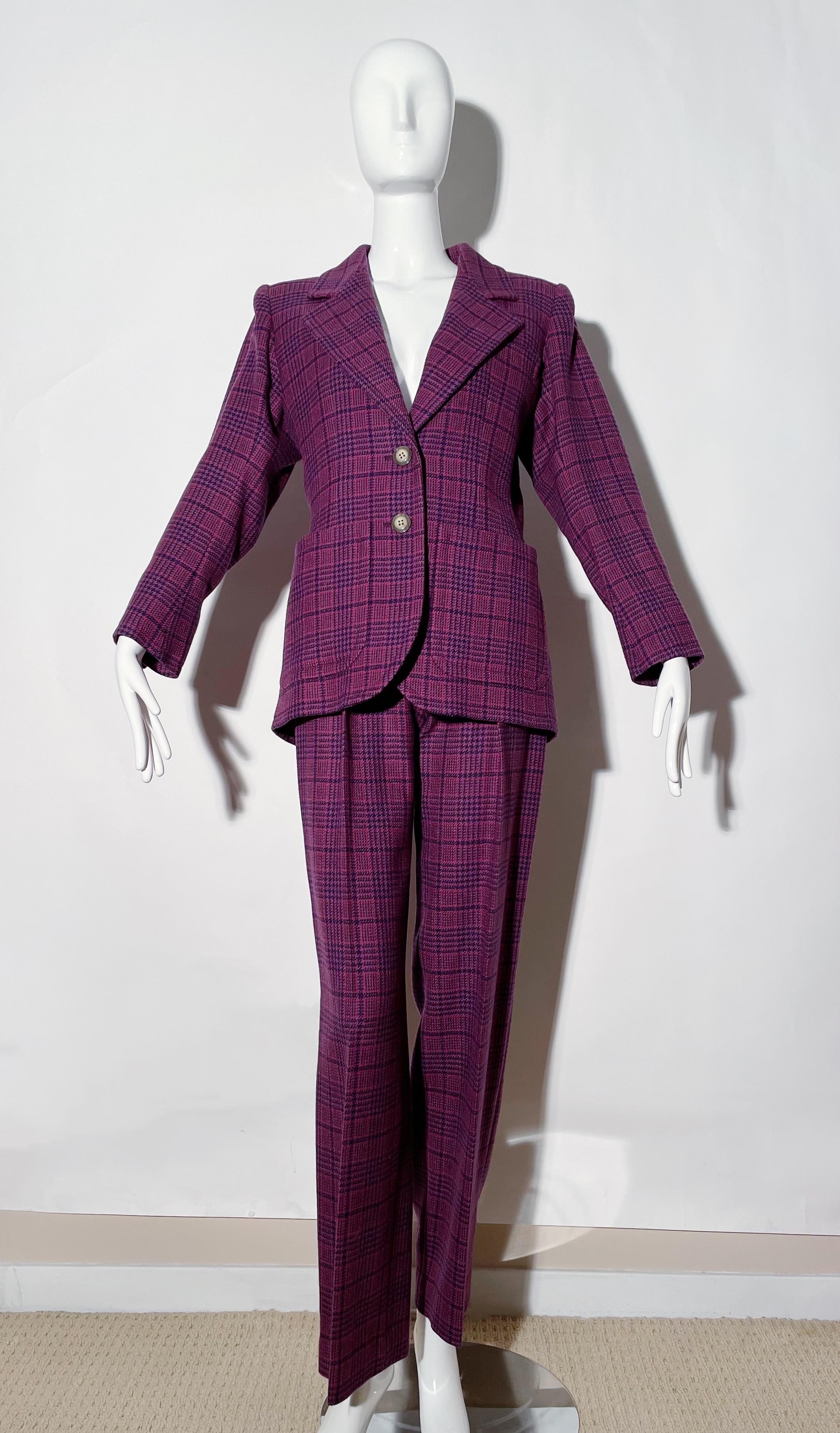 Purple plaid suit. Front button closures. Front pockets. Shoulder pads. Pleated trousers. Front zipper on trousers. Lined. Wool. Made in France. 
*Condition: excellent vintage condition. No visible flaws.

Measurements Taken Laying Flat