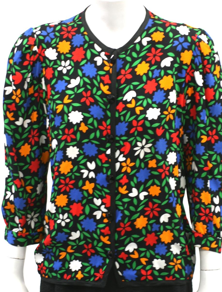 YSL rayon crepe vibrant floral print jacket with black soutache trim and jet buttons. Slightly fitted with puff shoulders and 3/4 gathered sleeves. Can also be worn as a blouse. 1990's France. 
Vintage size 38.  22