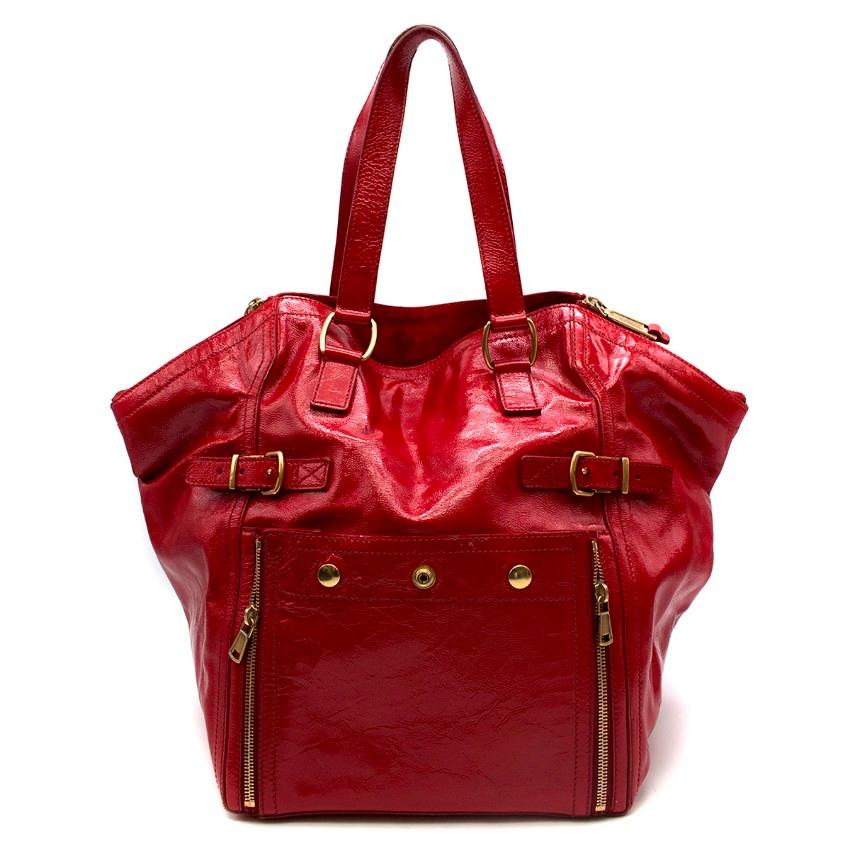 Yves Saint Laurent Red Downtown Tote Bag

- Red tote bag in lacquer red
- Gold-tone hardware
- Leather handles
- Short side zipper closure
- Two side buttoned pockets wit zappers for expansion
- Black lining
- Decorative buckle straps
- Middle zip