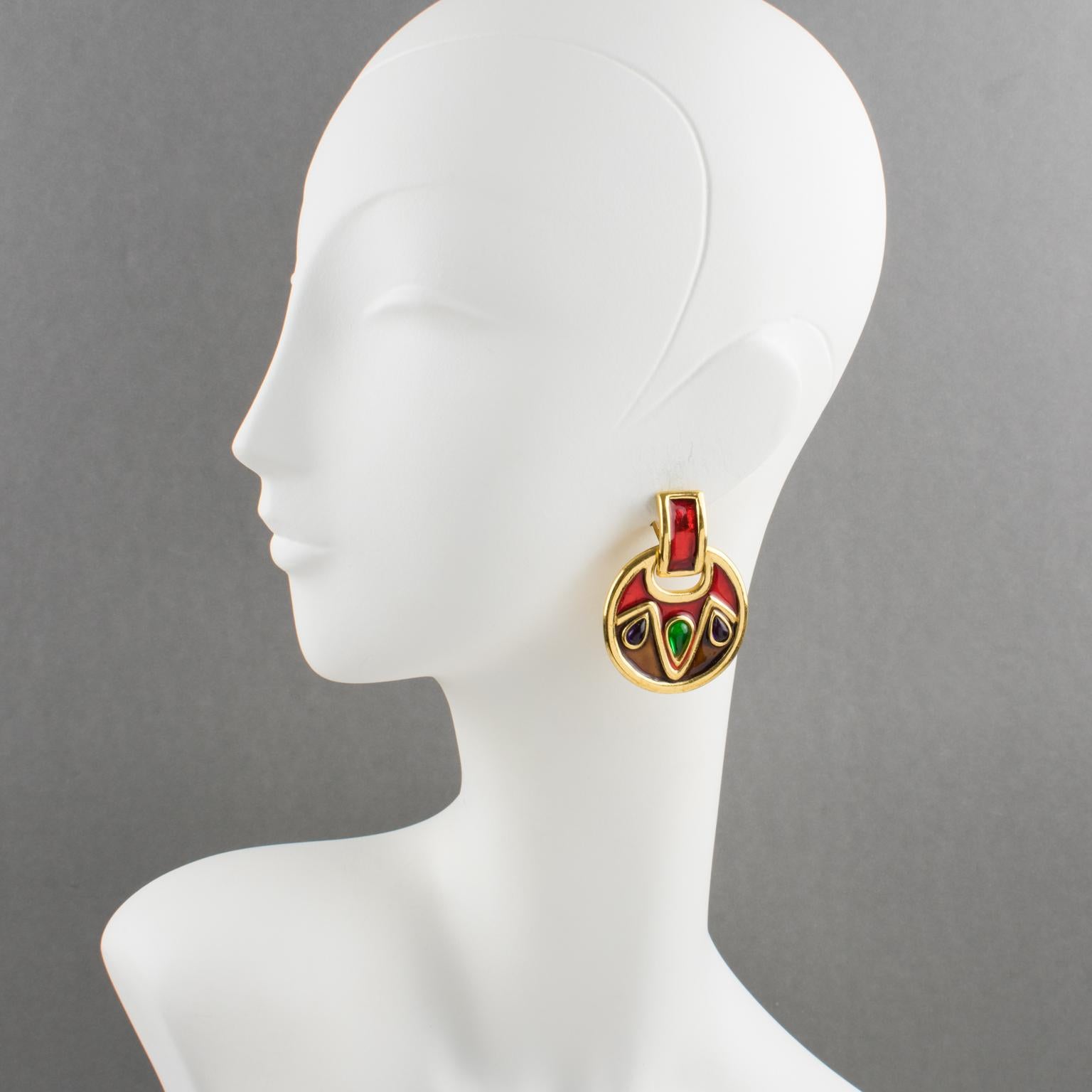 Lovely Yves Saint Laurent YSL Paris signed clip-on earrings. Oversized dangle shape, featuring a door knocker with a geometric design. Shiny gilt metal framing with texture ornate with candy apple red and cinnamon brown enamel. The earrings are also