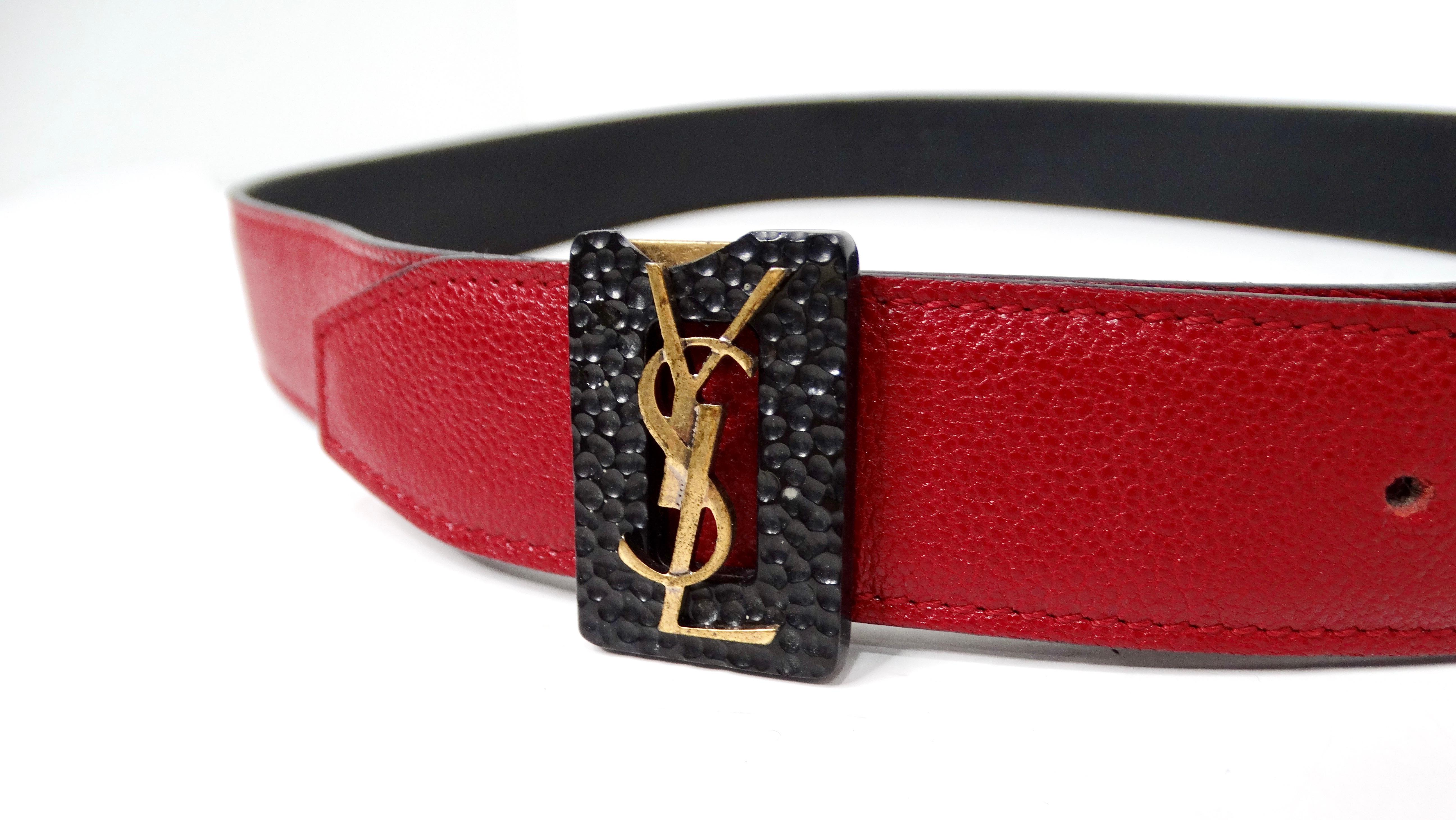 The Yves Saint Laurent Red Leather Belt with Gold-Tone Logo Buckle is a stunning accessory that perfectly exemplifies the blend of luxury and modern style that defines the YSL brand. Crafted from premium red leather, this belt features a striking