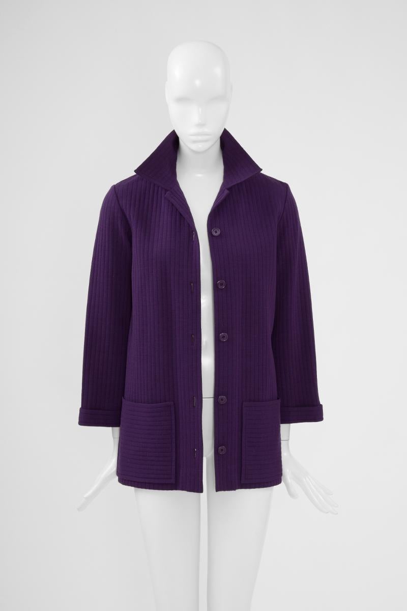 Made of a deep purple ribbed wool jersey, this early 70's YSL jacket combines sleek tailoring and relaxed fit. Shirt collar, it fastens with six glossy buttons down the front and has two roomy patch pockets. Layer it over a turtleneck and jeans.