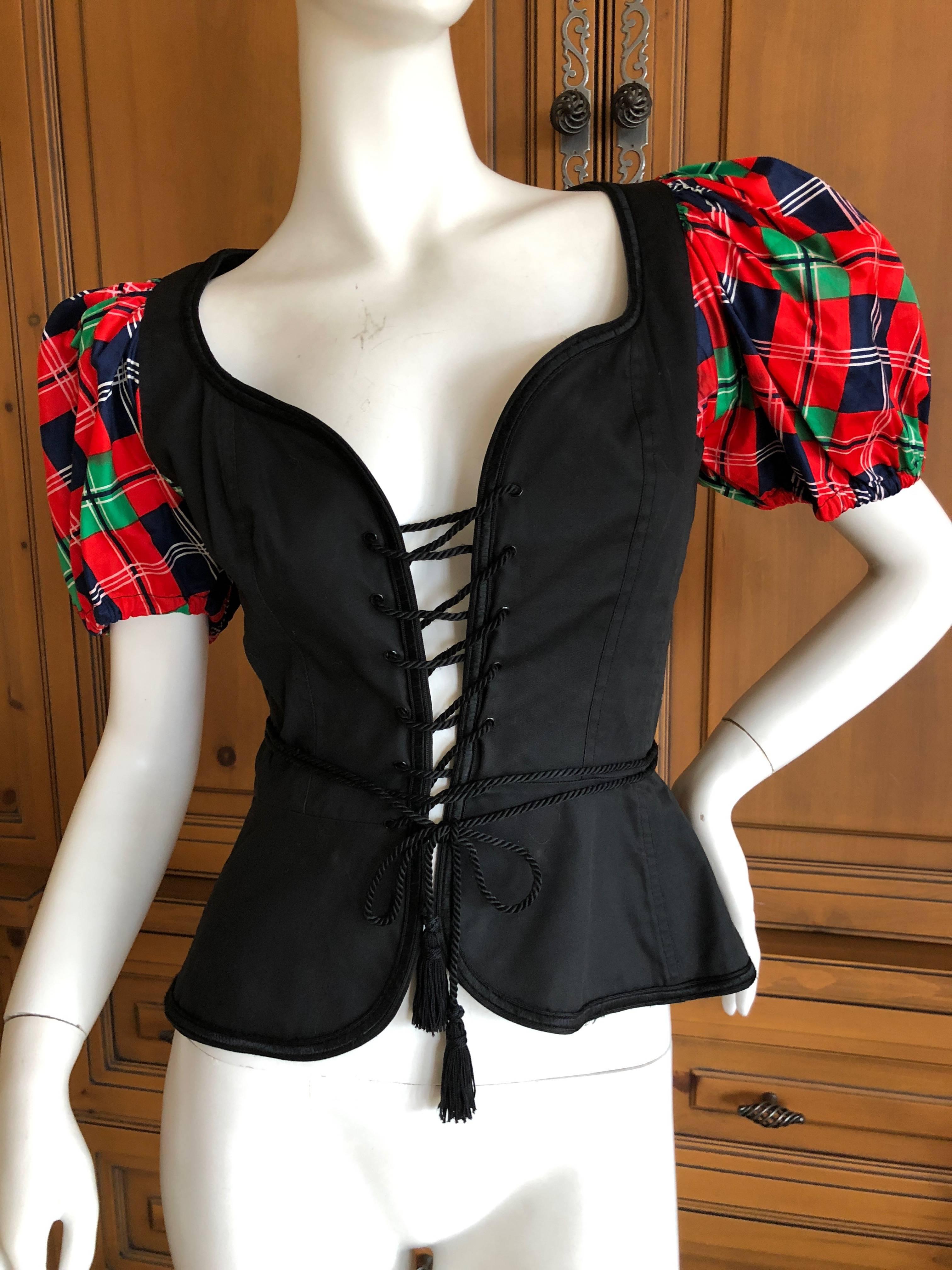 Yves Saint Laurent Rive Gauche 1970's Corset Lace Peasant Top.
The corset lace peasant top has been a signature YSL Style since the beginning of the house.
This is a very early example of the corset lace peasant top, with plaid silk sleeves.
Sz