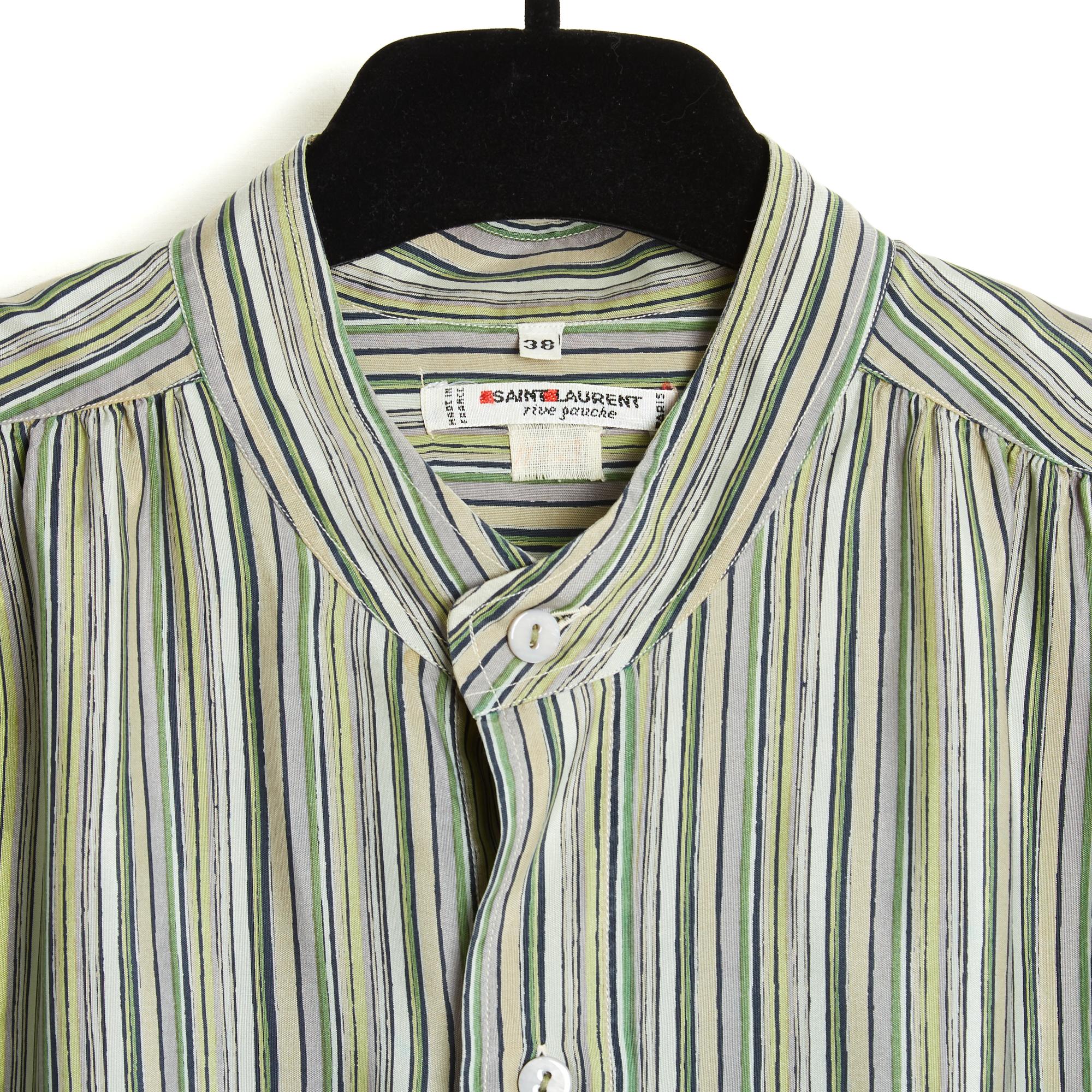 Top Yves Saint Laurent Rive Gauche circa 1985 blouse or rather silk shirt with stripes in different shades of green, round neck closed by 7 buttons in front, long slightly batwing sleeves closed by 3 buttons each. Size 38FR (shouldered and oversize,