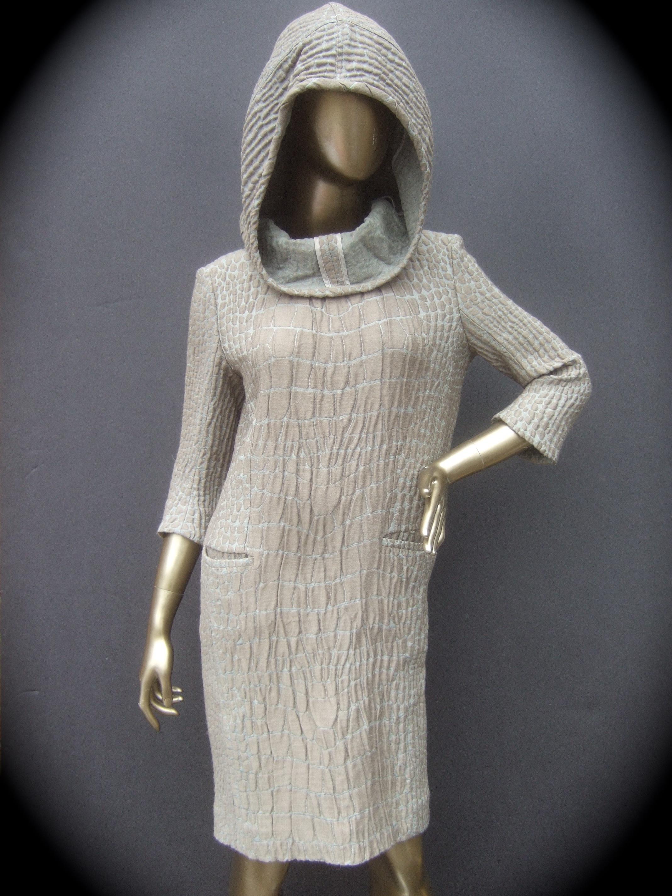 Yves Saint Laurent Rive Gauche Avant-garde hooded dress 
The edgy boxy tunic style dress is designed with a subtle textured crinkled pattern that emulates reptile scales

The unique design may be worn with the hood placed over the head; for a