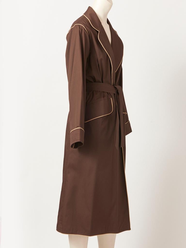 Yves Saint Laurent, Rive Gauche, chocolate brown, cotton, belted, robe style coat from the late 70's. This coat is styled like a man's robe , Maxi in length,having a beige piping/trim along the lapels, shoulders, collar, pockets, cuffs and the