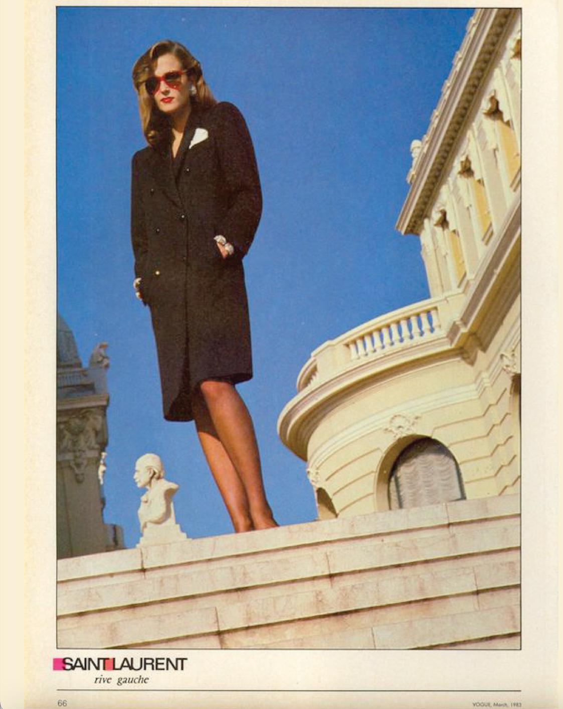 S/S 1983 Yves Saint Laurent Rive Gauche black wool tuxedo blazer dress. Double-breasted above-knee dress with silk lapels. Oversized black button closures at front and wrists. As seen on the runway, and featured in Vogue March 1983. A classic piece